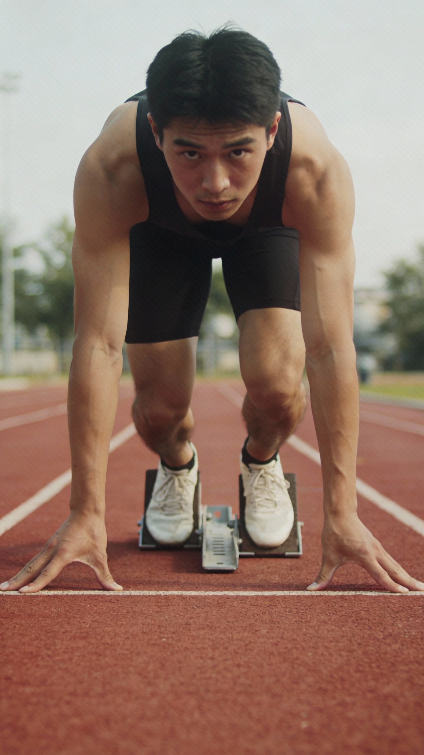 Sprinter in Starting Position on Running Track
