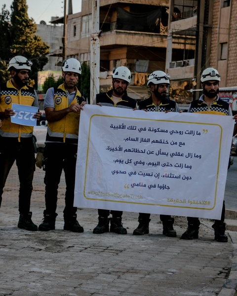 Civil Defense Workers Hold Protest Banner