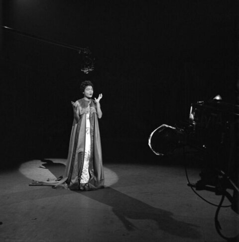 Female Performer Under Stage Spotlight