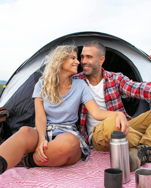 Happy Couple Camping at Tent Entrance