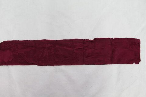 Burgundy fabric strip on white background