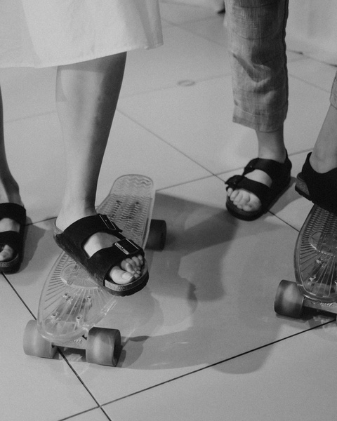 Feet Standing on Mini Skateboards