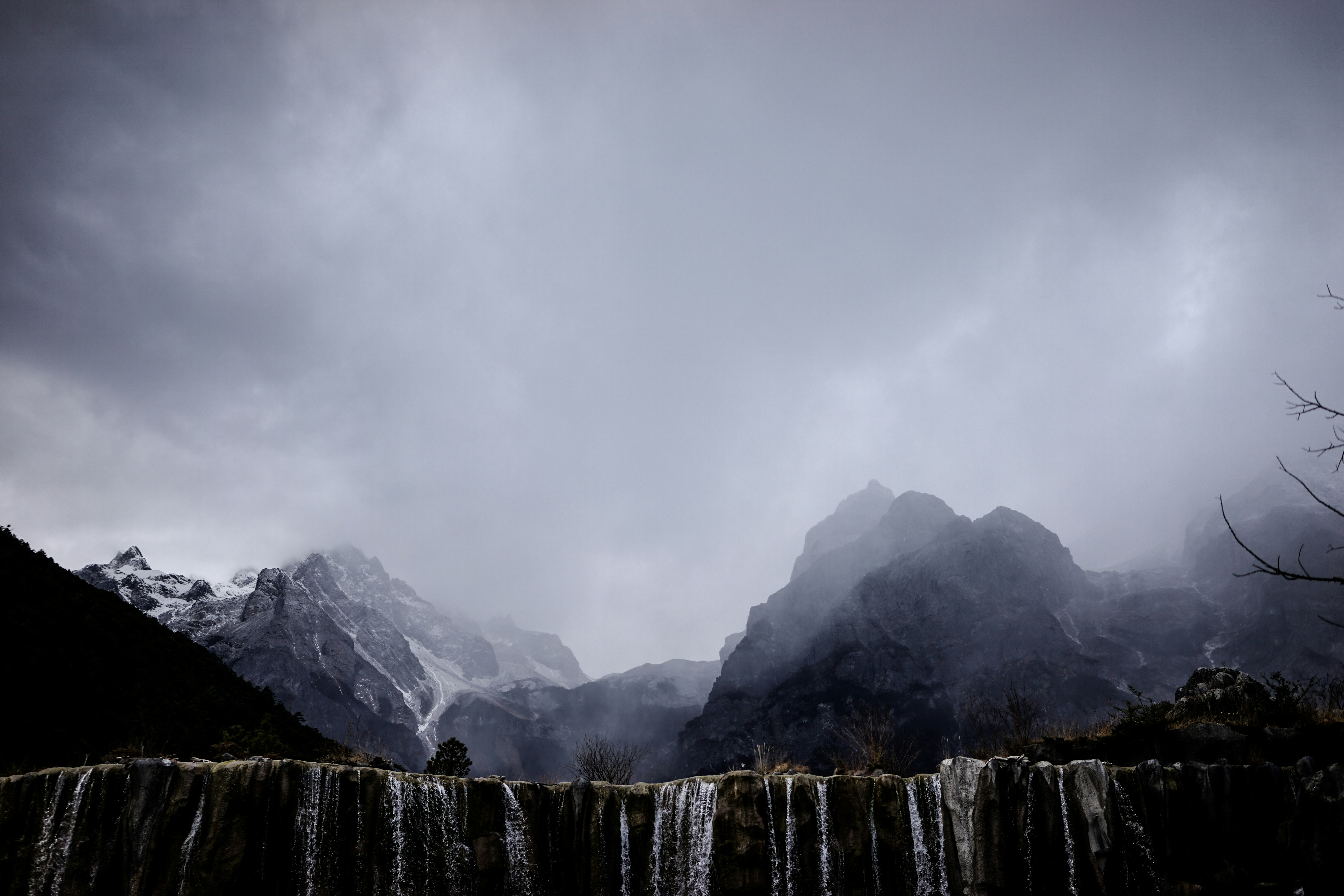 Misty Snow Mountains with Waterfall