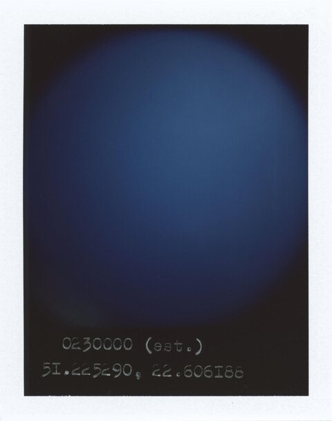 Blue Polaroid with Handwritten Coordinates