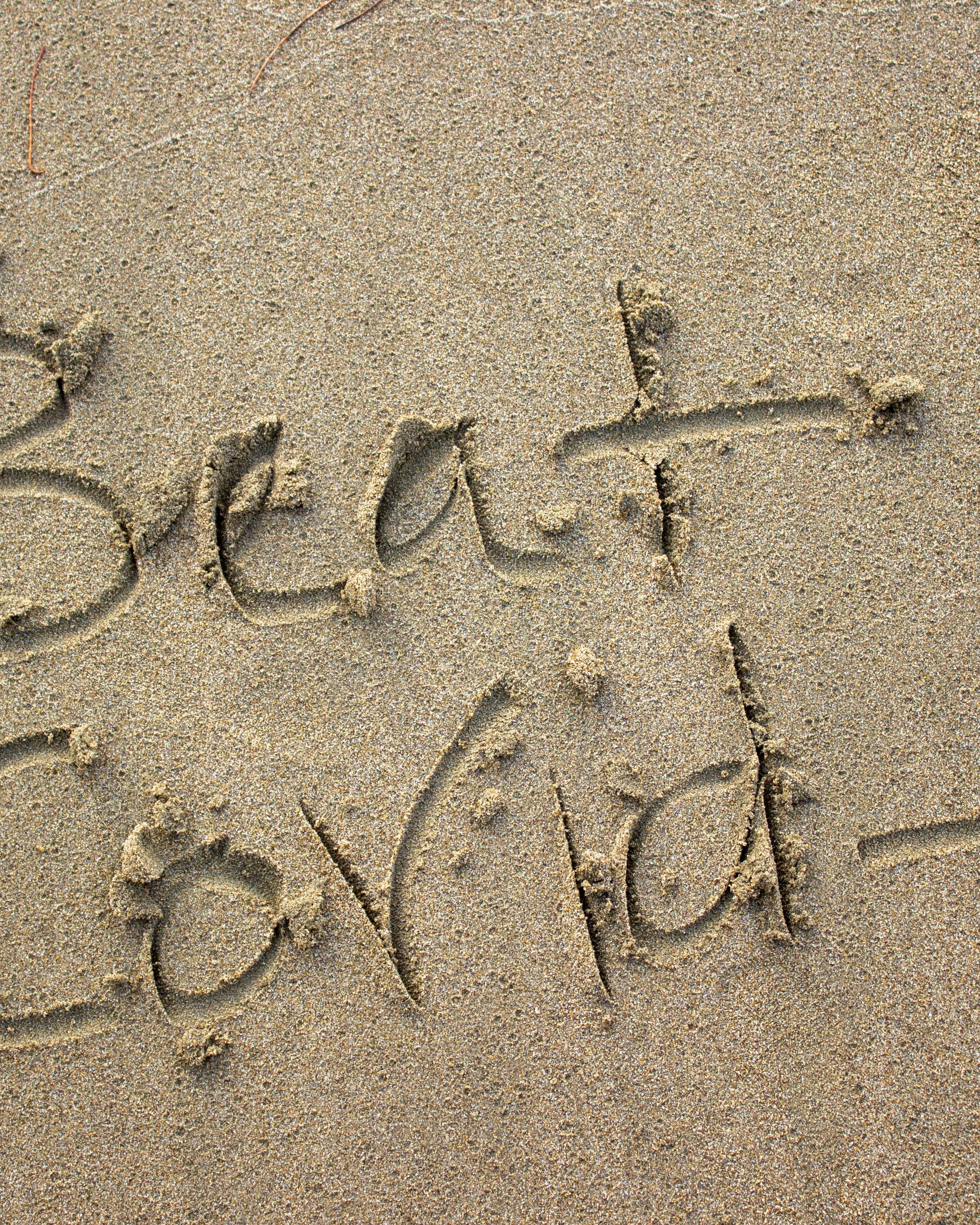 Beat Covid Written in Beach Sand