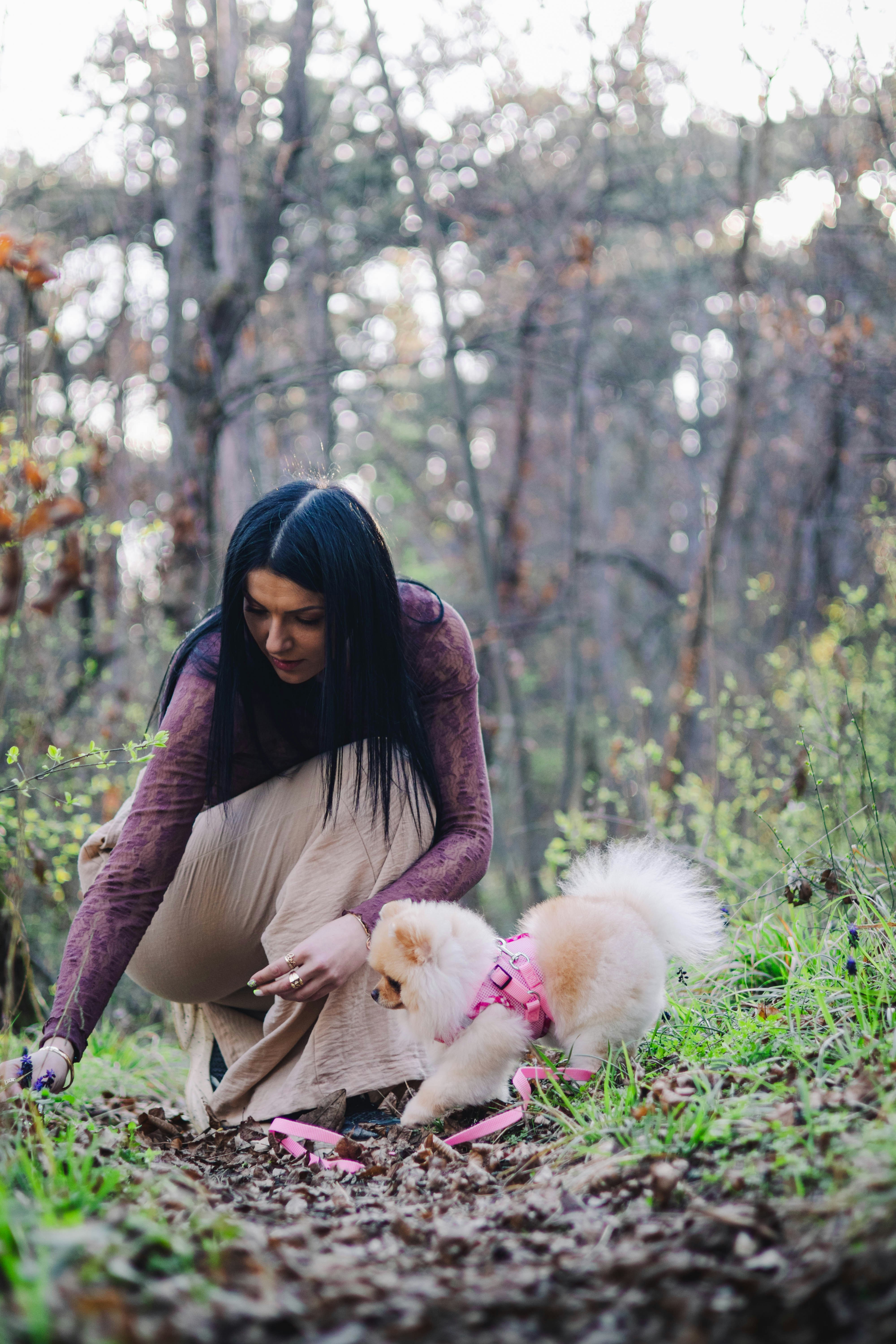 Woman and Pomeranian in Early Spring Woods