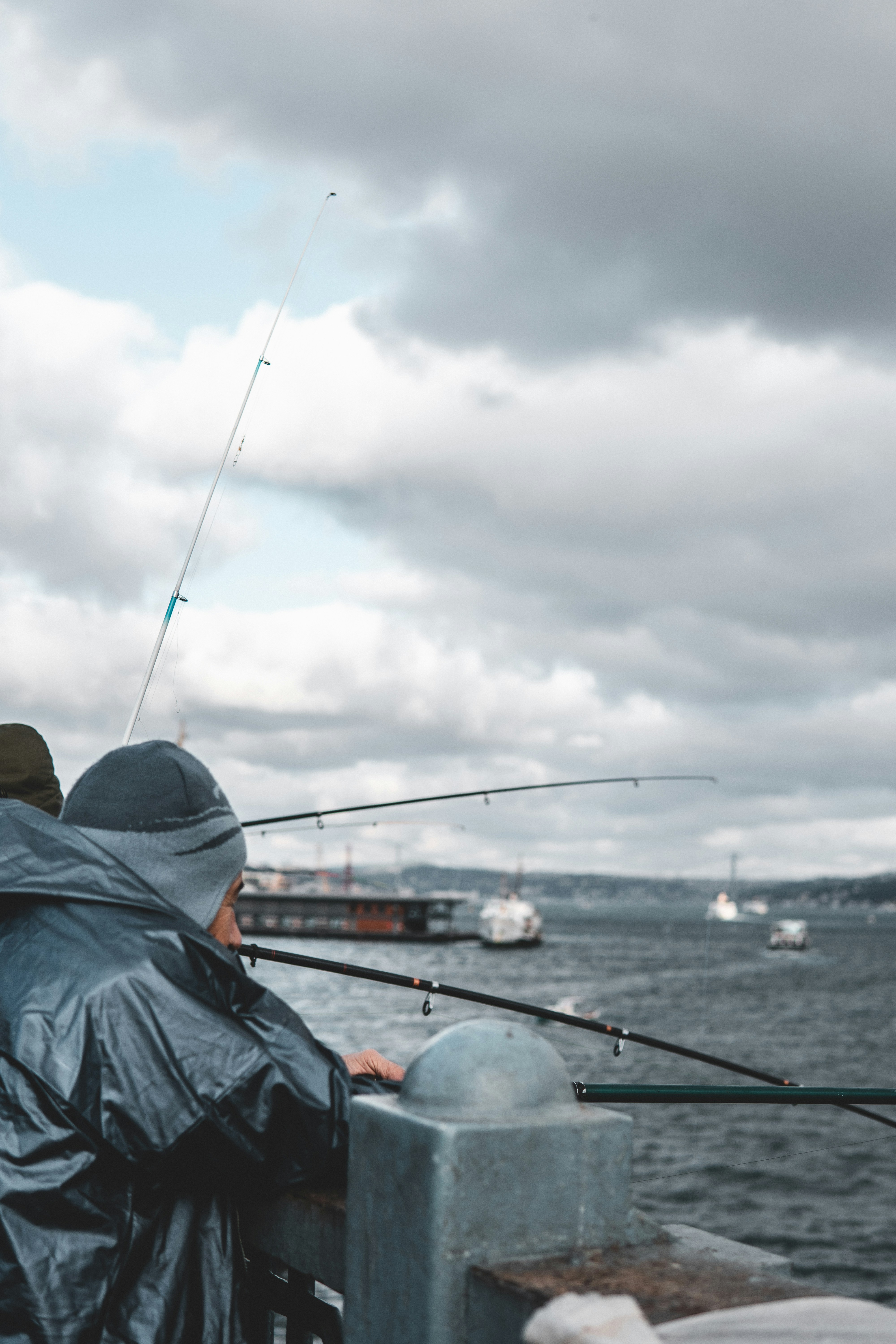Fishermen Fishing on Waterfront Pier