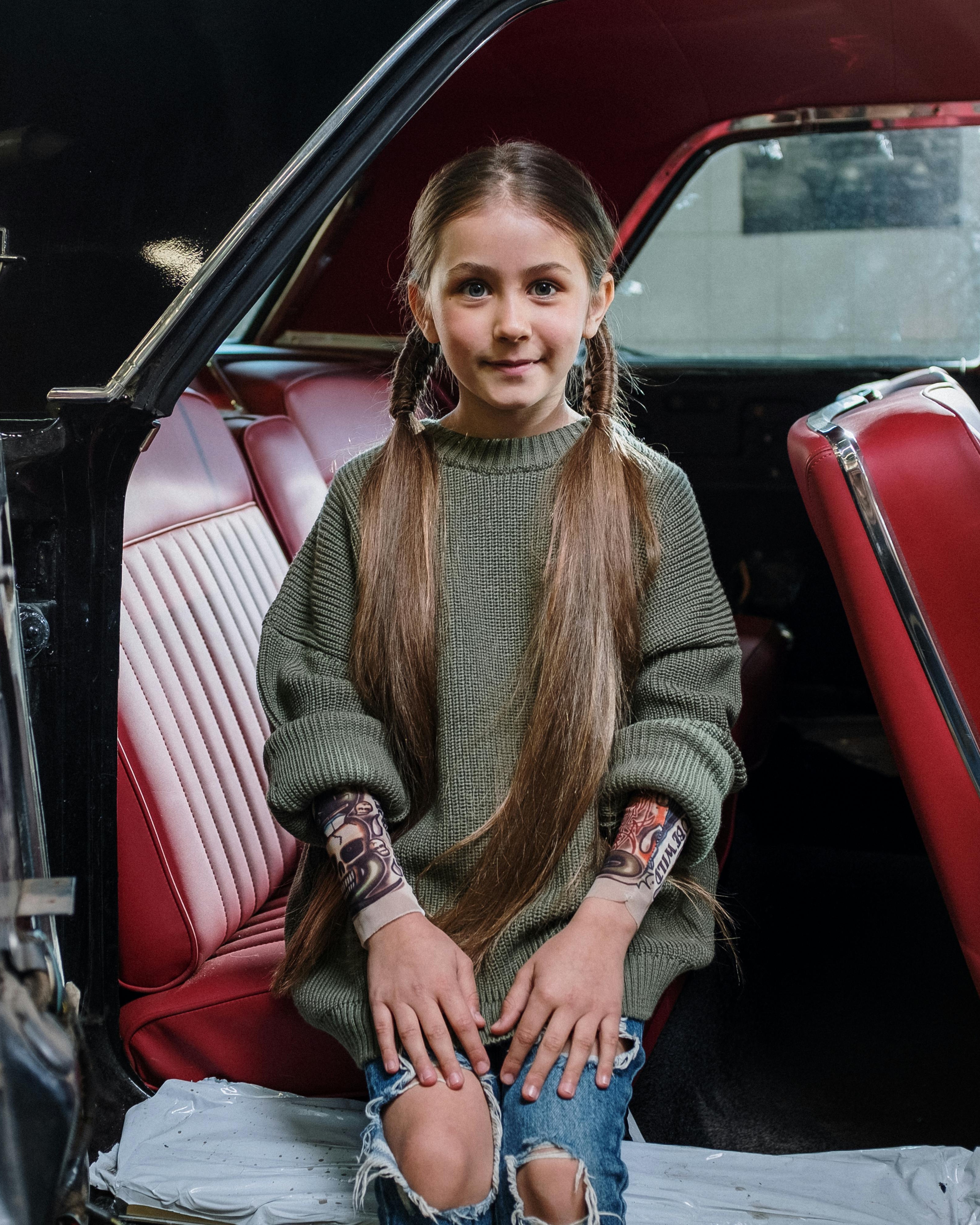 Girl With Fake Tattoos In Classic Car