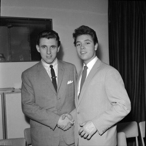 Two Suited Young Men Shaking Hands