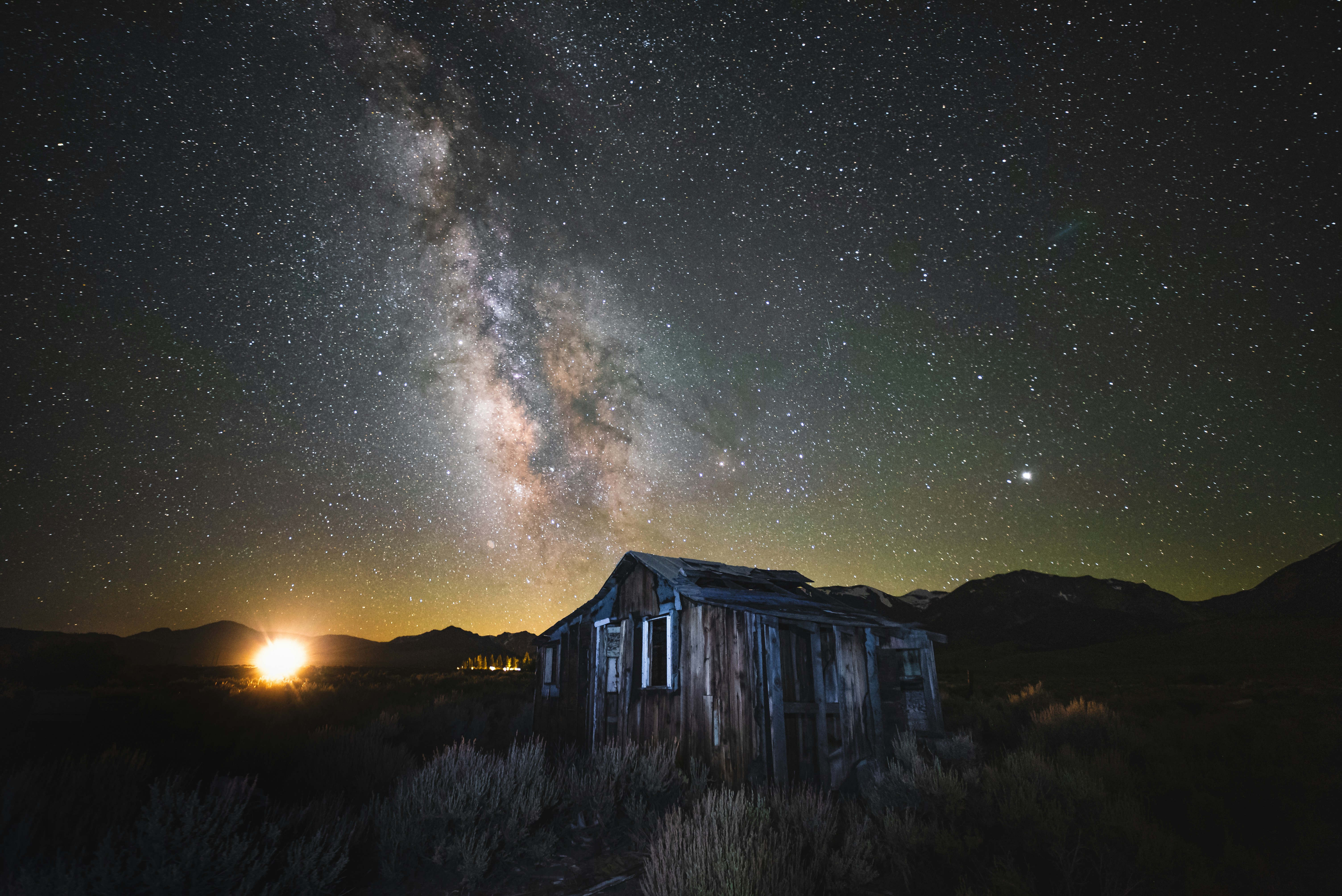 Abandoned Cabin Under Milky Way Night Sky
