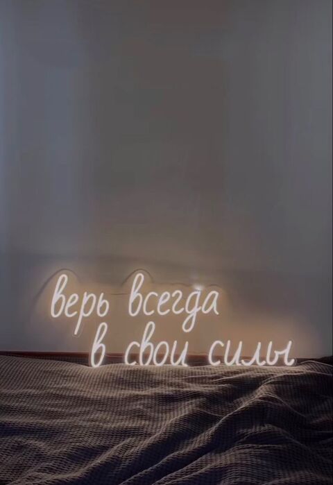 Glowing Russian Neon Sign Above Bed