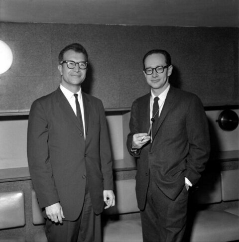 Two Suited Men Posing For Portrait