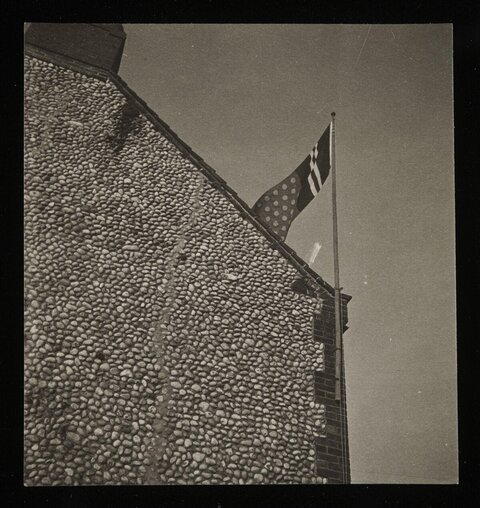 Cobblestone Building with Flag
