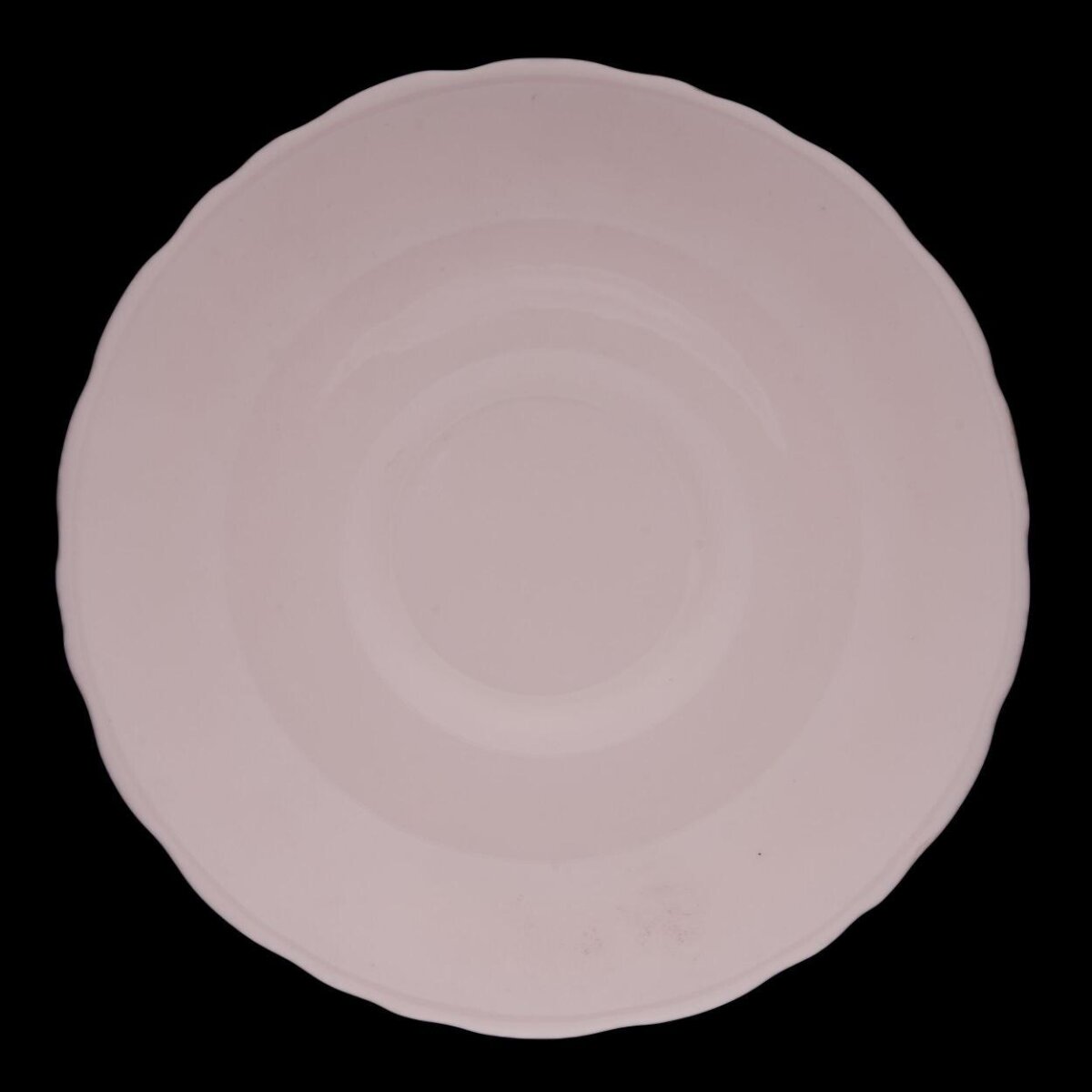 White Scalloped Saucer on Black Background