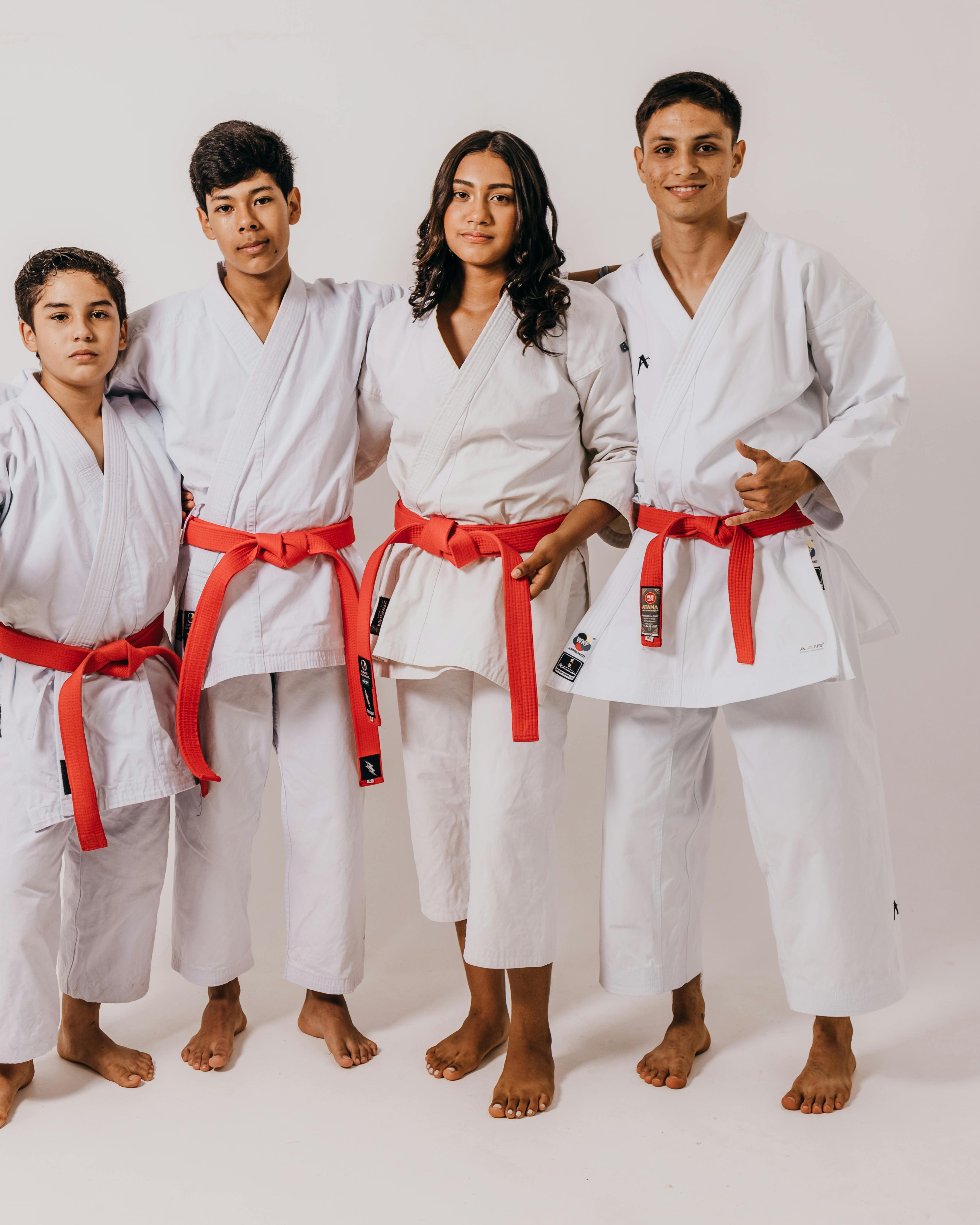 Four Karate Athletes with Red Belts