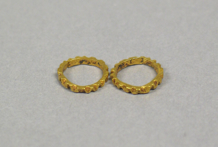Two Gold Gear-shaped Rings