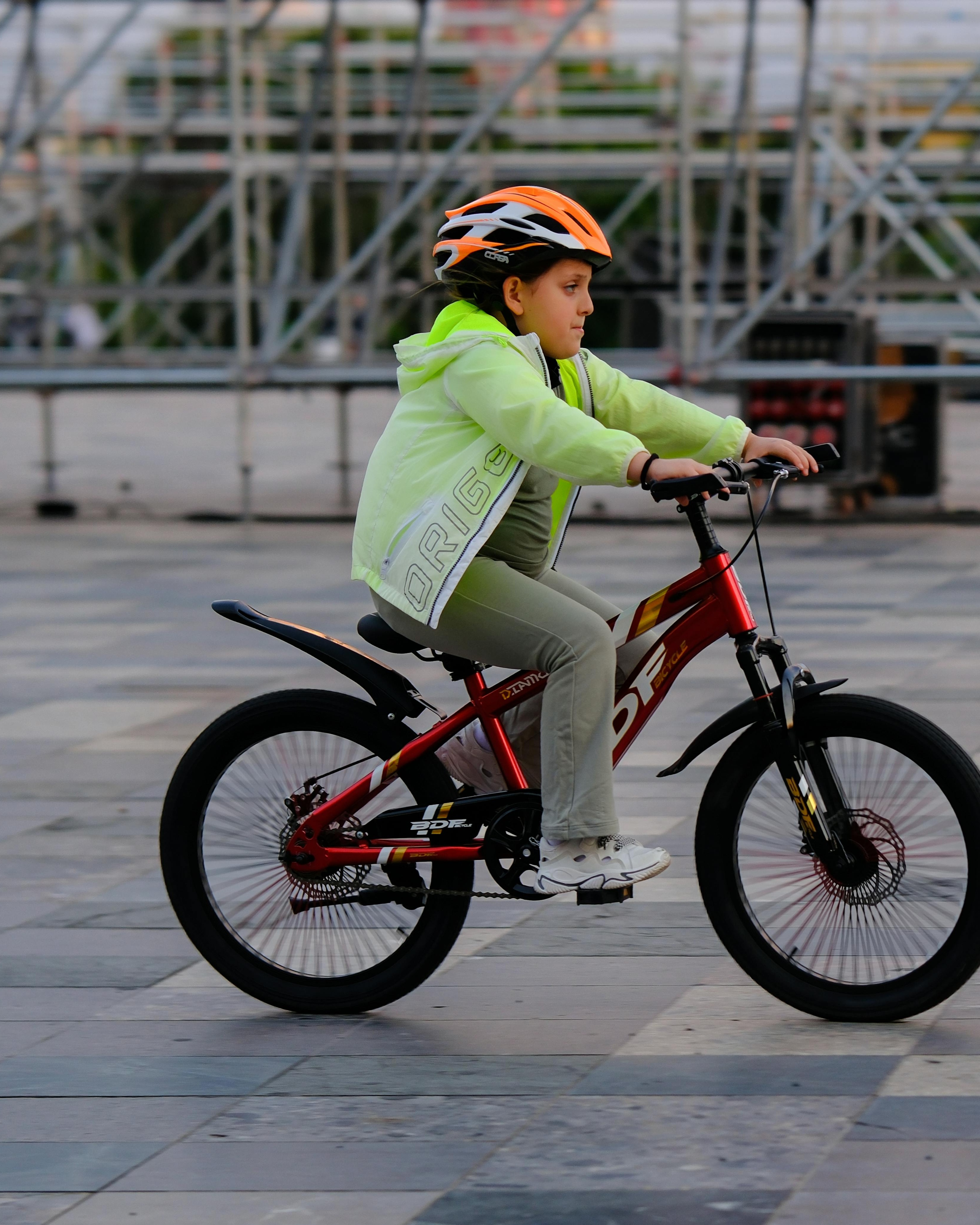 Girl Riding Bicycle In Public Plaza