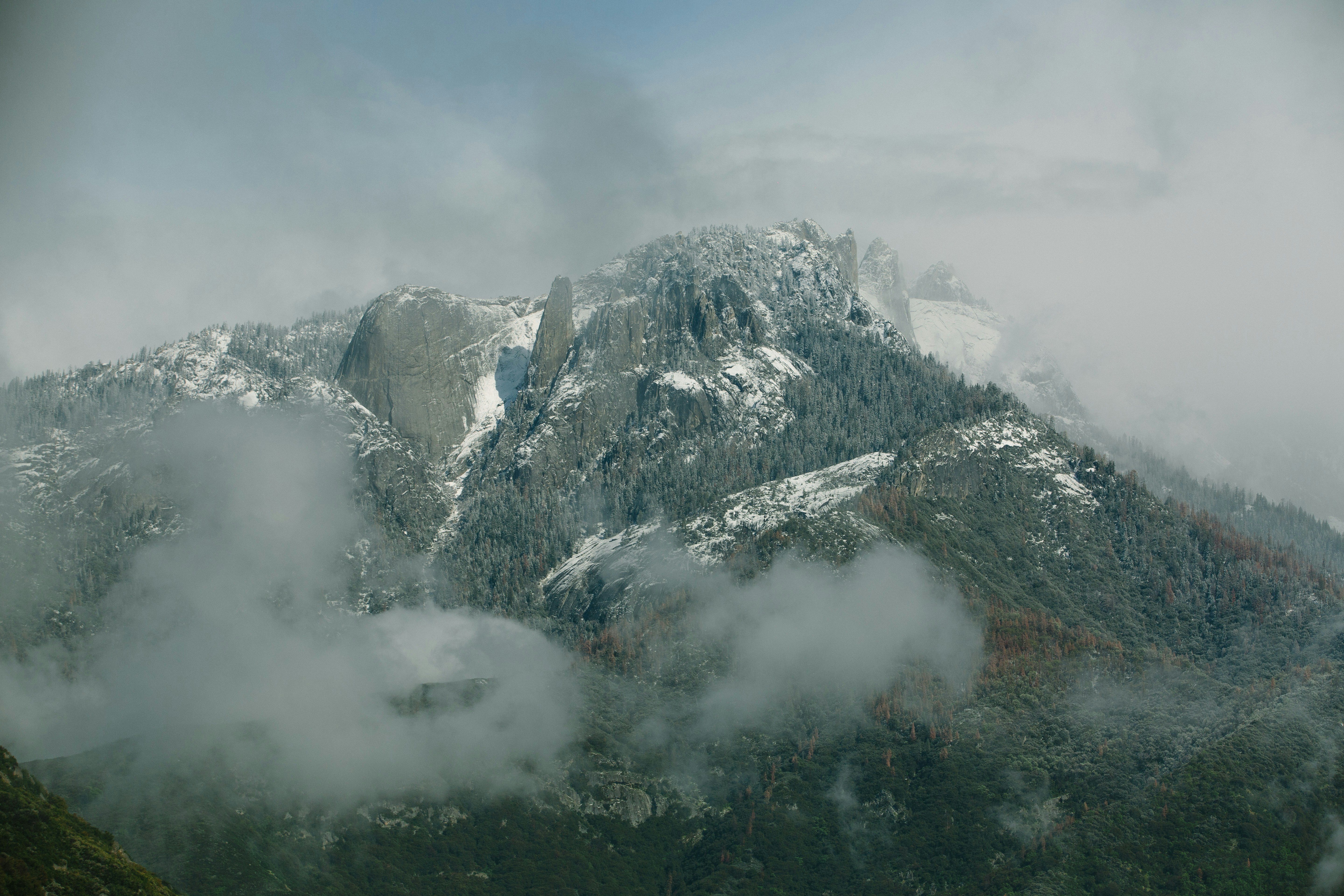 Snow-capped Mountains Enveloped in Fog