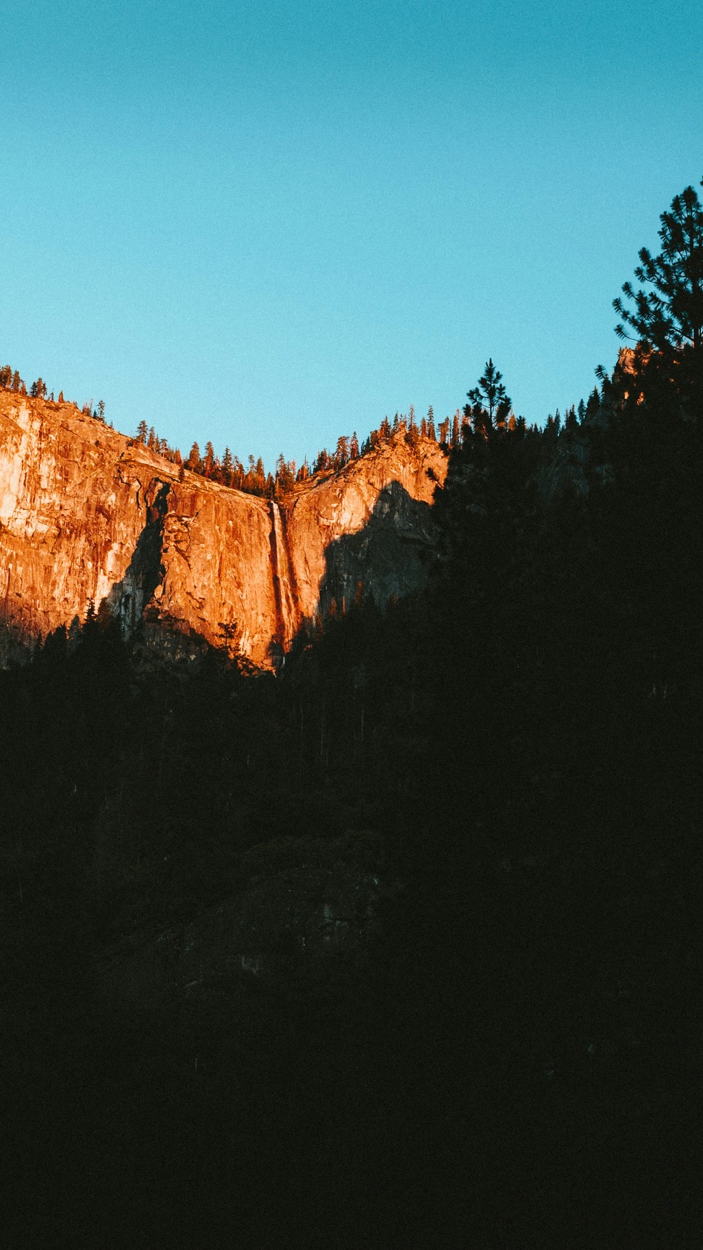 Sunlit Mountain Cliff at Sunset
