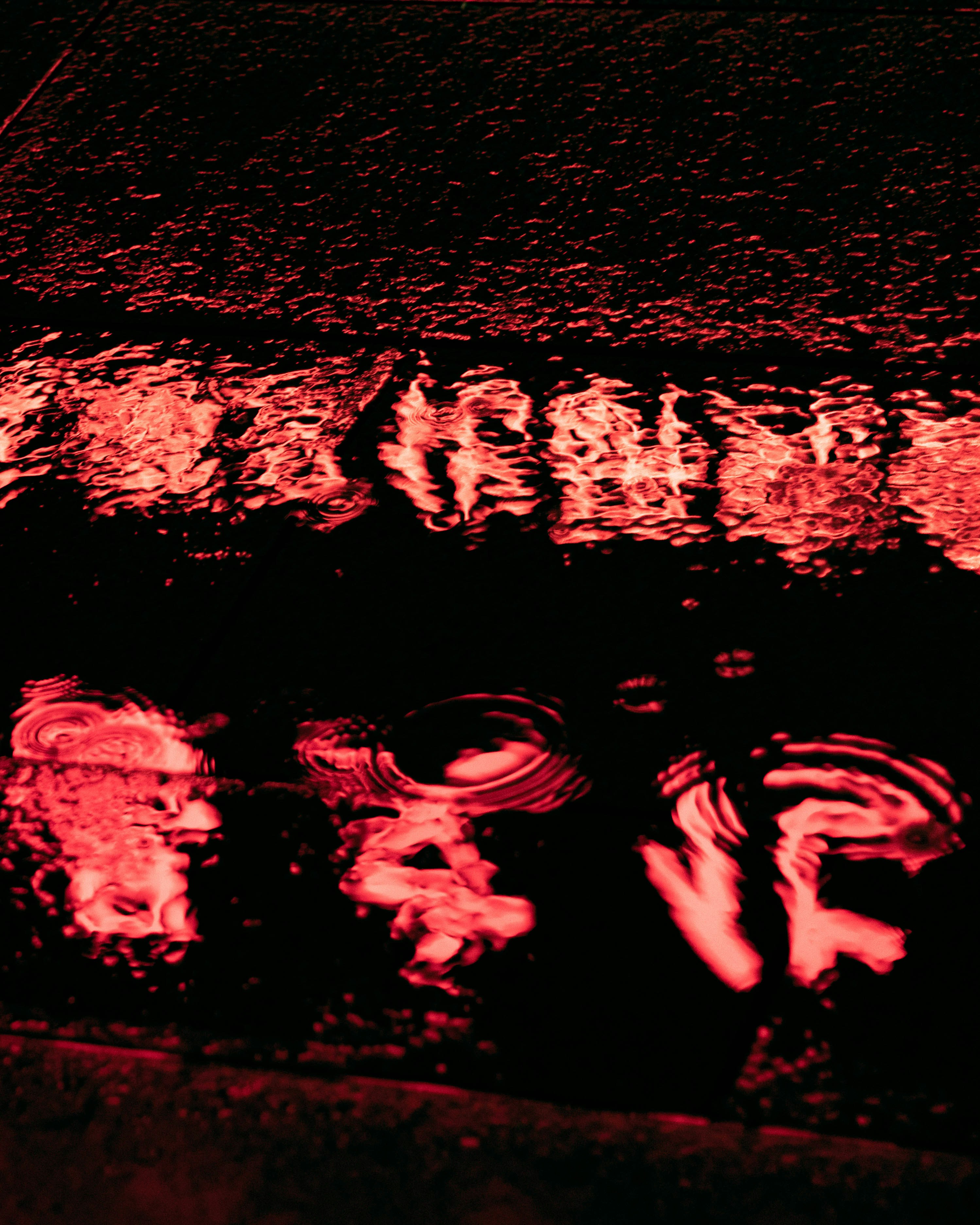 Red Light Reflection on Rippled Water