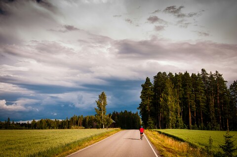 Cyclist Riding on Country Road