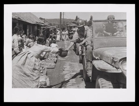 Soldier Buying Produce From Street Vendor