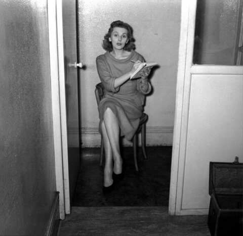 Woman Taking Notes in Doorway