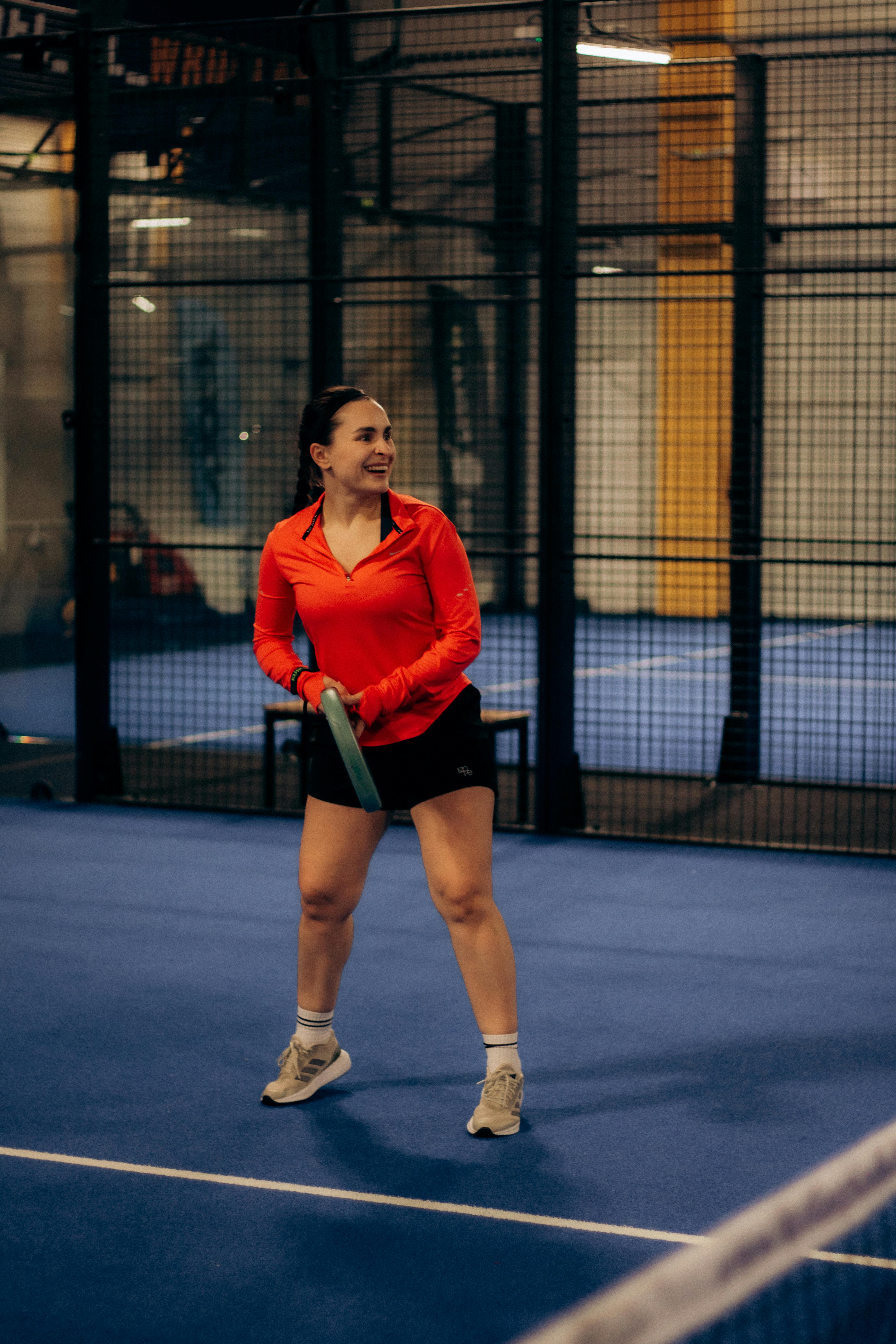 Woman Playing Padel on Indoor Court