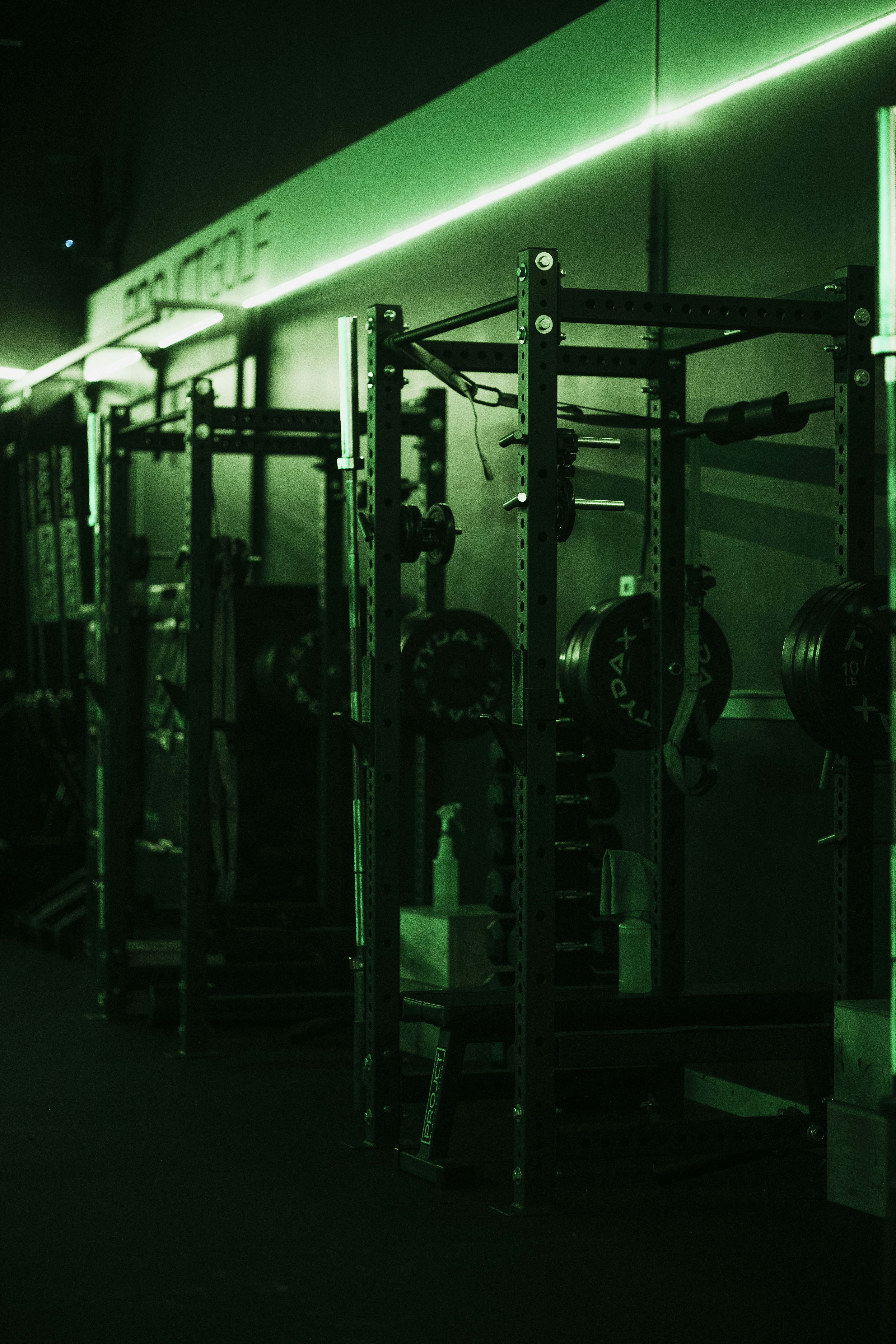 Gym Weight Racks Under Green Lighting