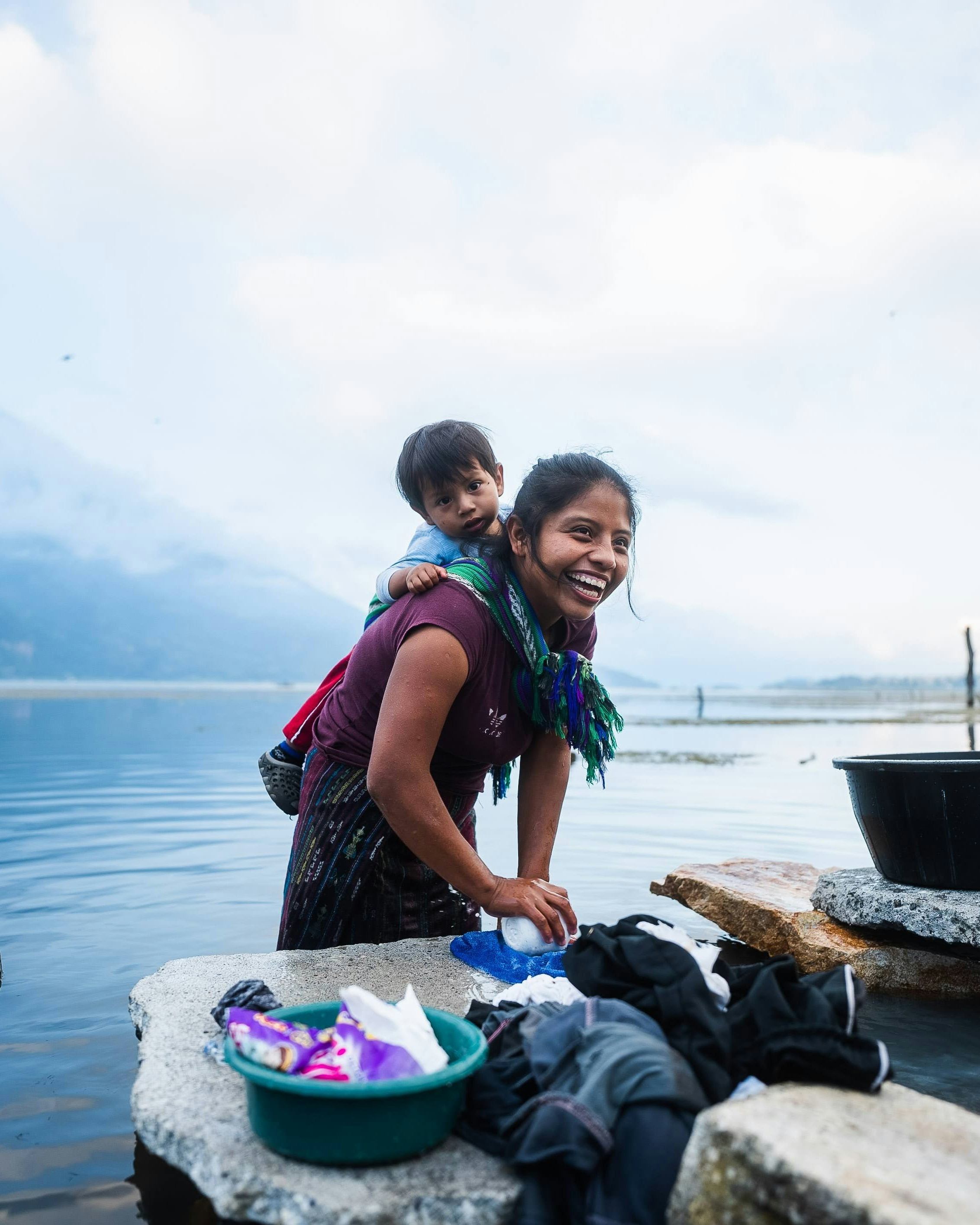 Mother Washing Clothes by Lakeside