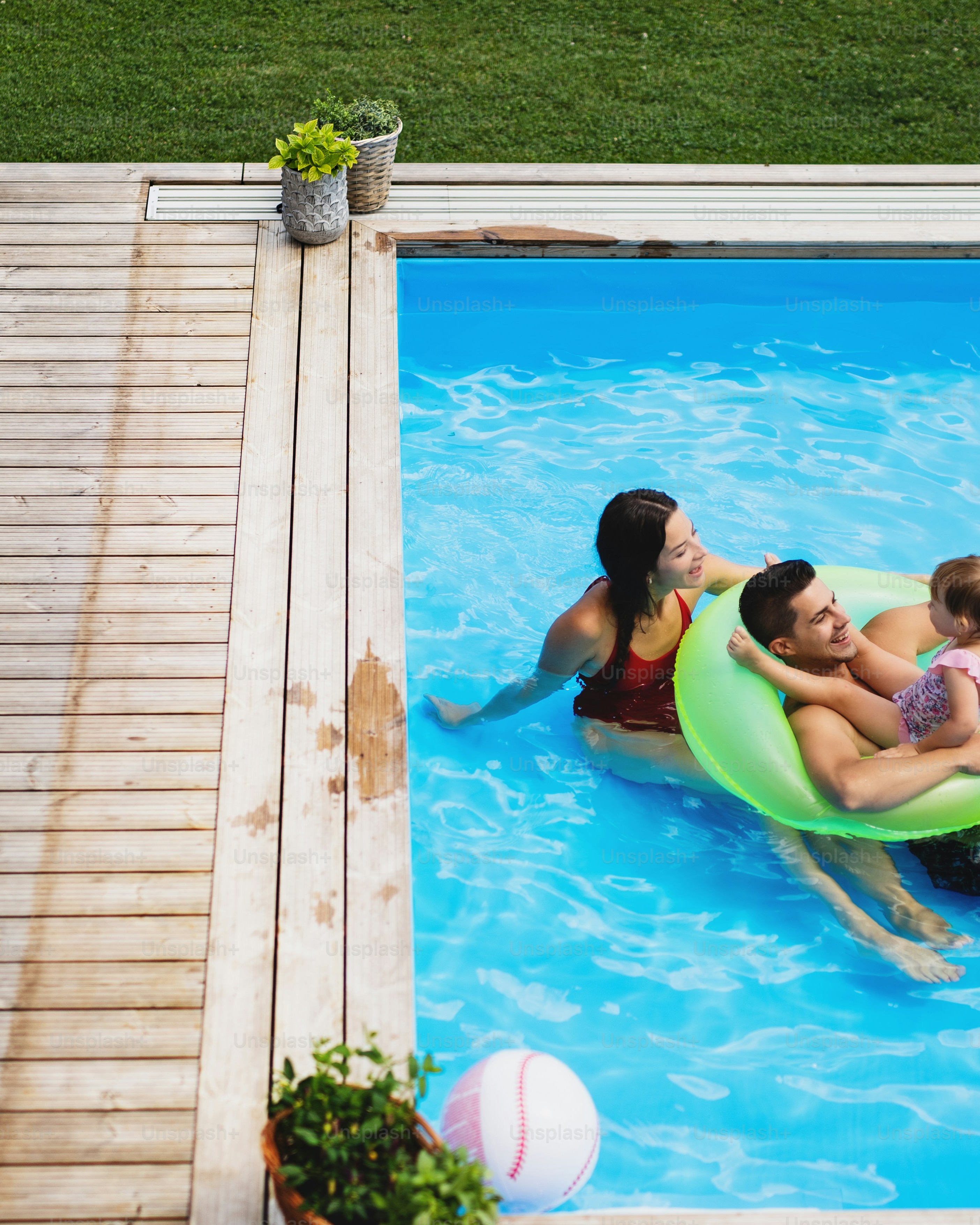 Family Relaxing in Backyard Pool