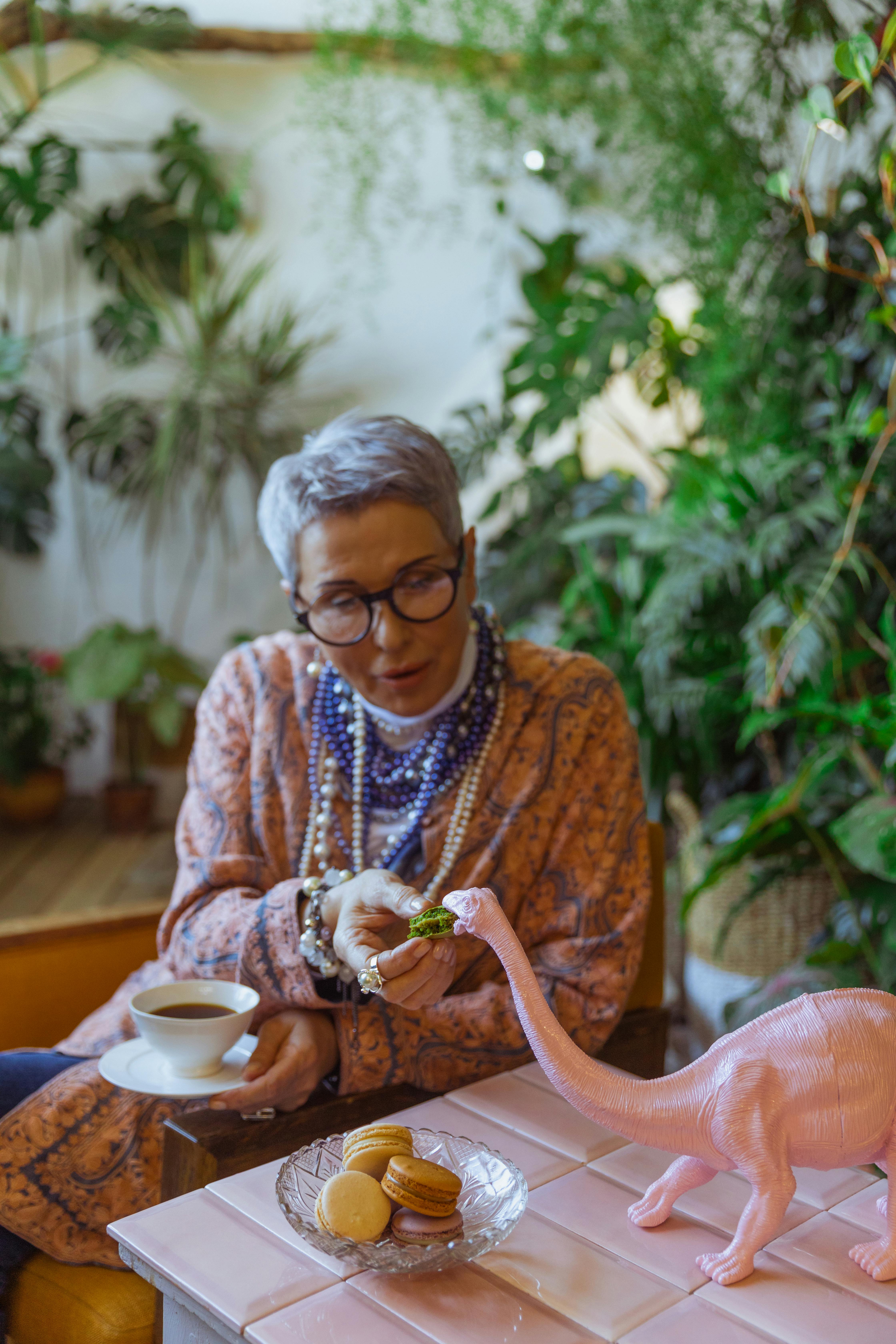 Woman Feeding Toy Dinosaur Macaron