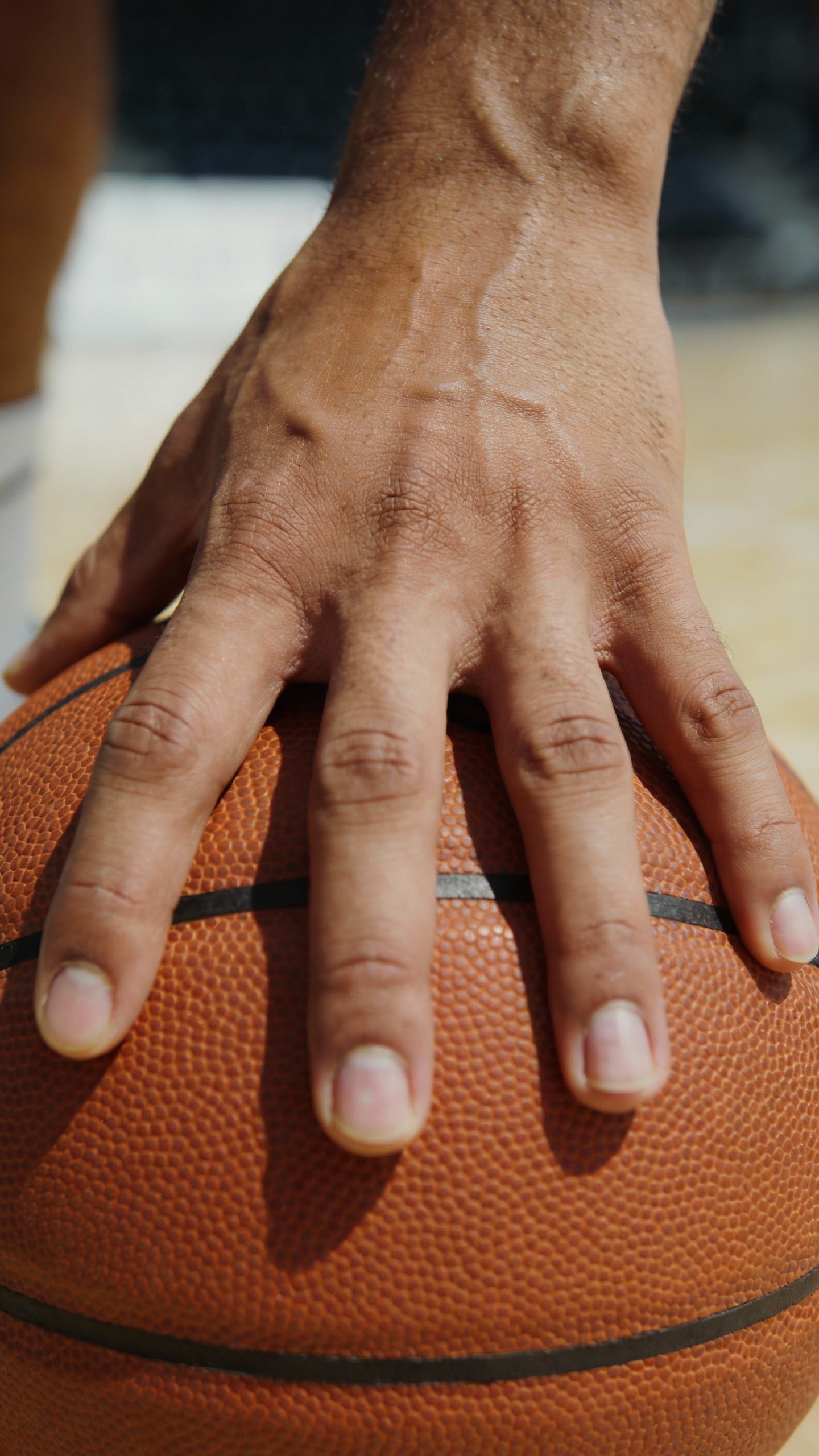 Hand Resting on a Basketball