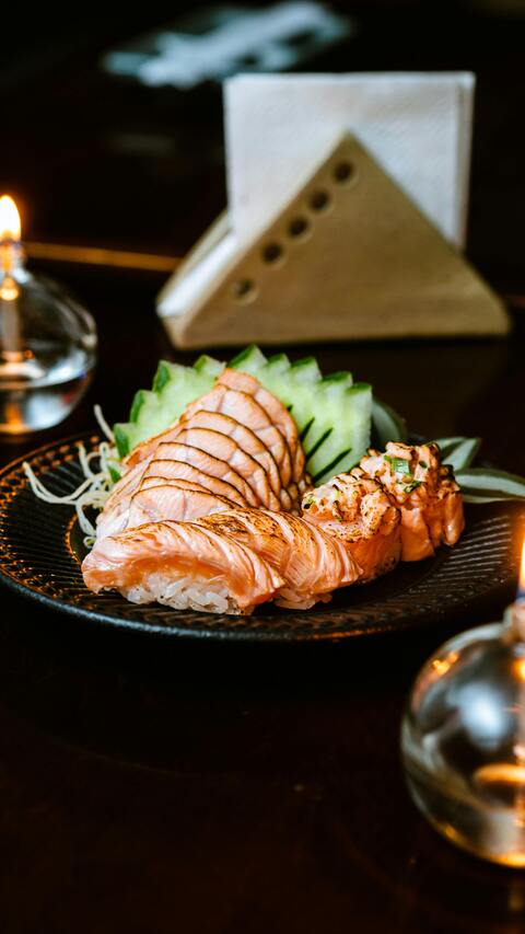 Seared Salmon Sushi on Black Plate