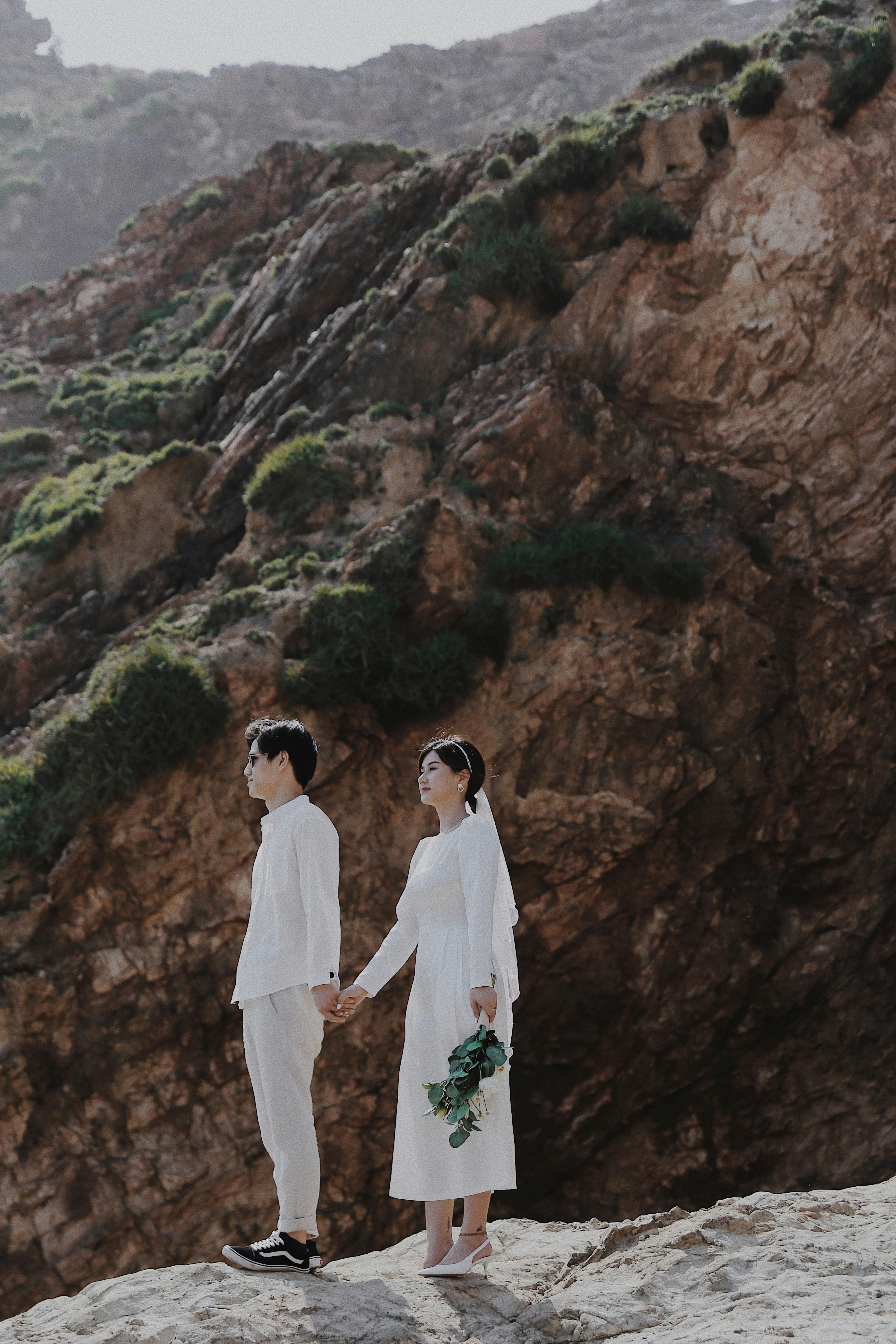 Newlywed Couple on Rocky Cliff