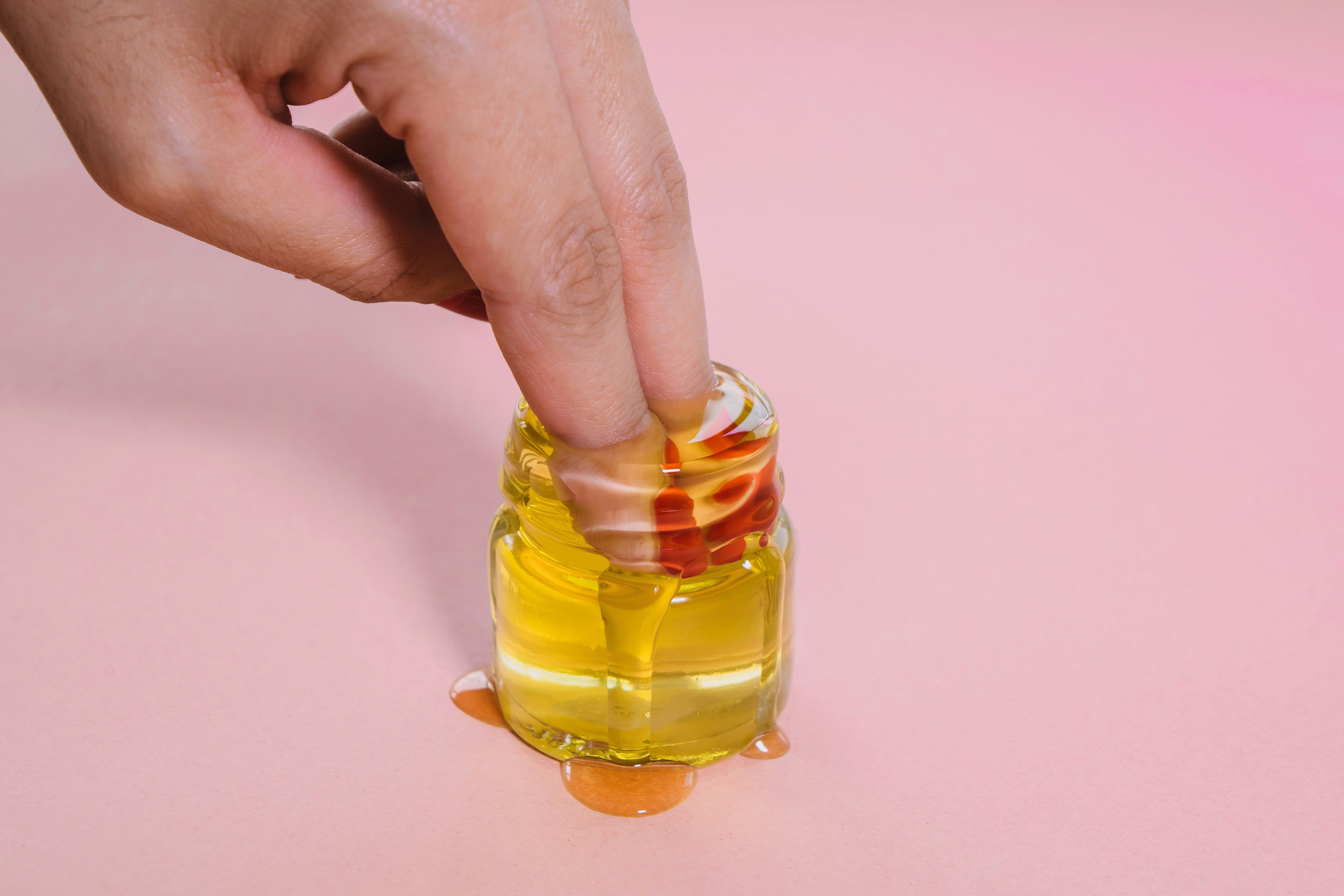 Two Fingers Dipped In Honey Jar