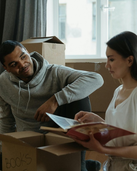 Couple Unpacking Books After Moving