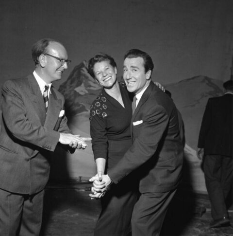 Three Smiling People Shaking Hands