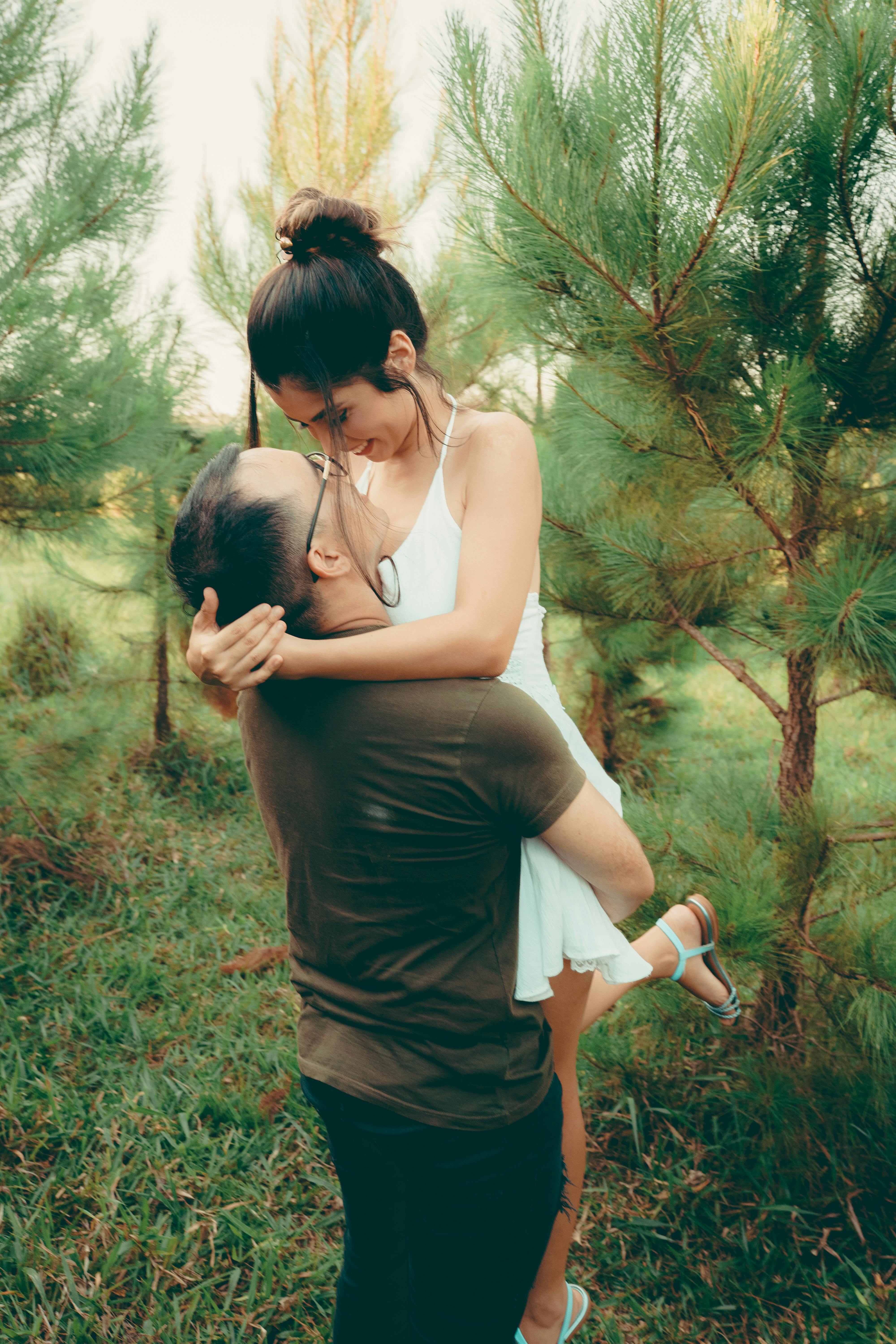 Couple Embracing Among Pine Trees