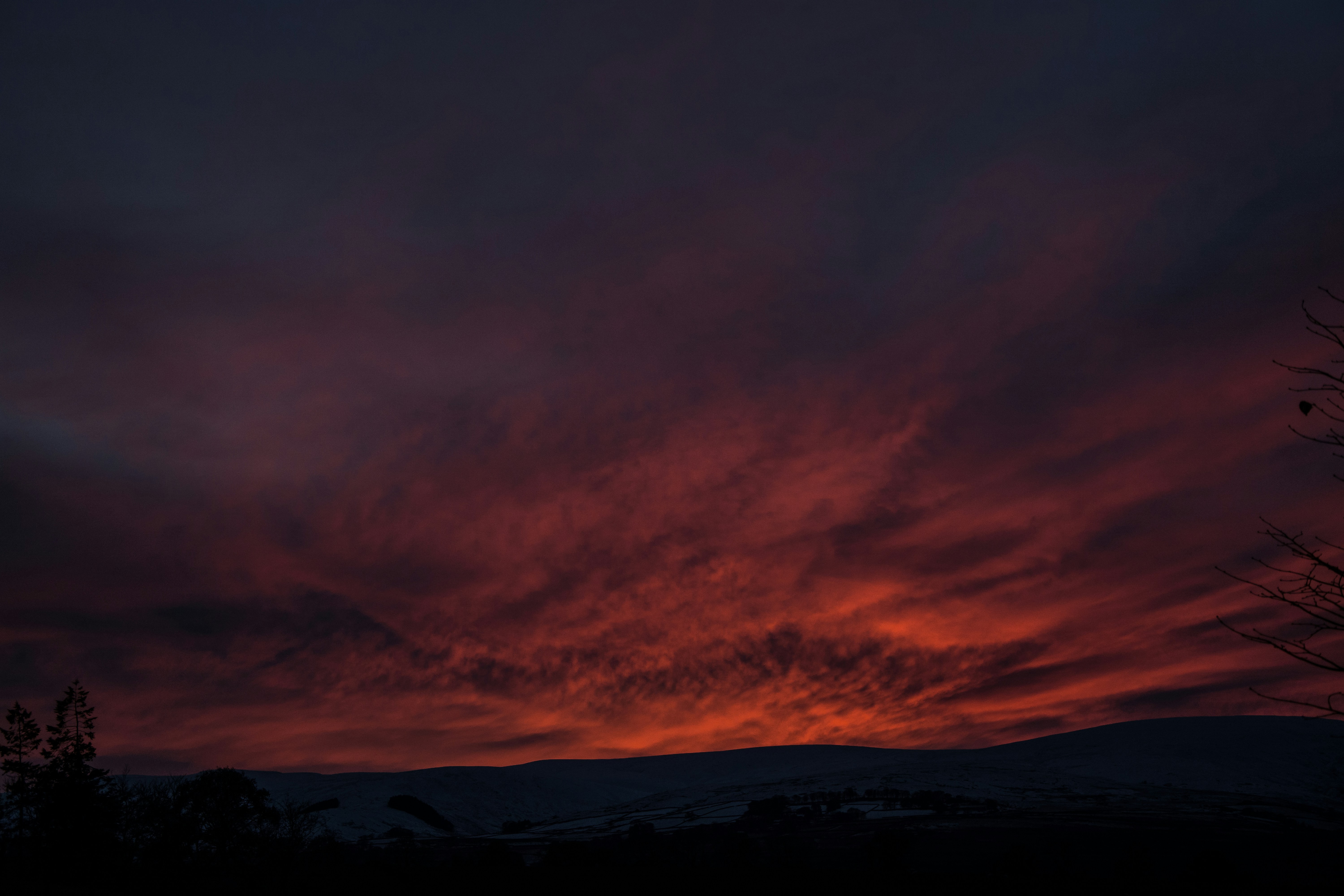 Fiery Red Sunset Over Hills