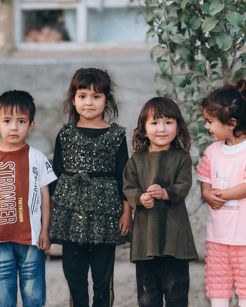 Four Young Children Standing In A Row