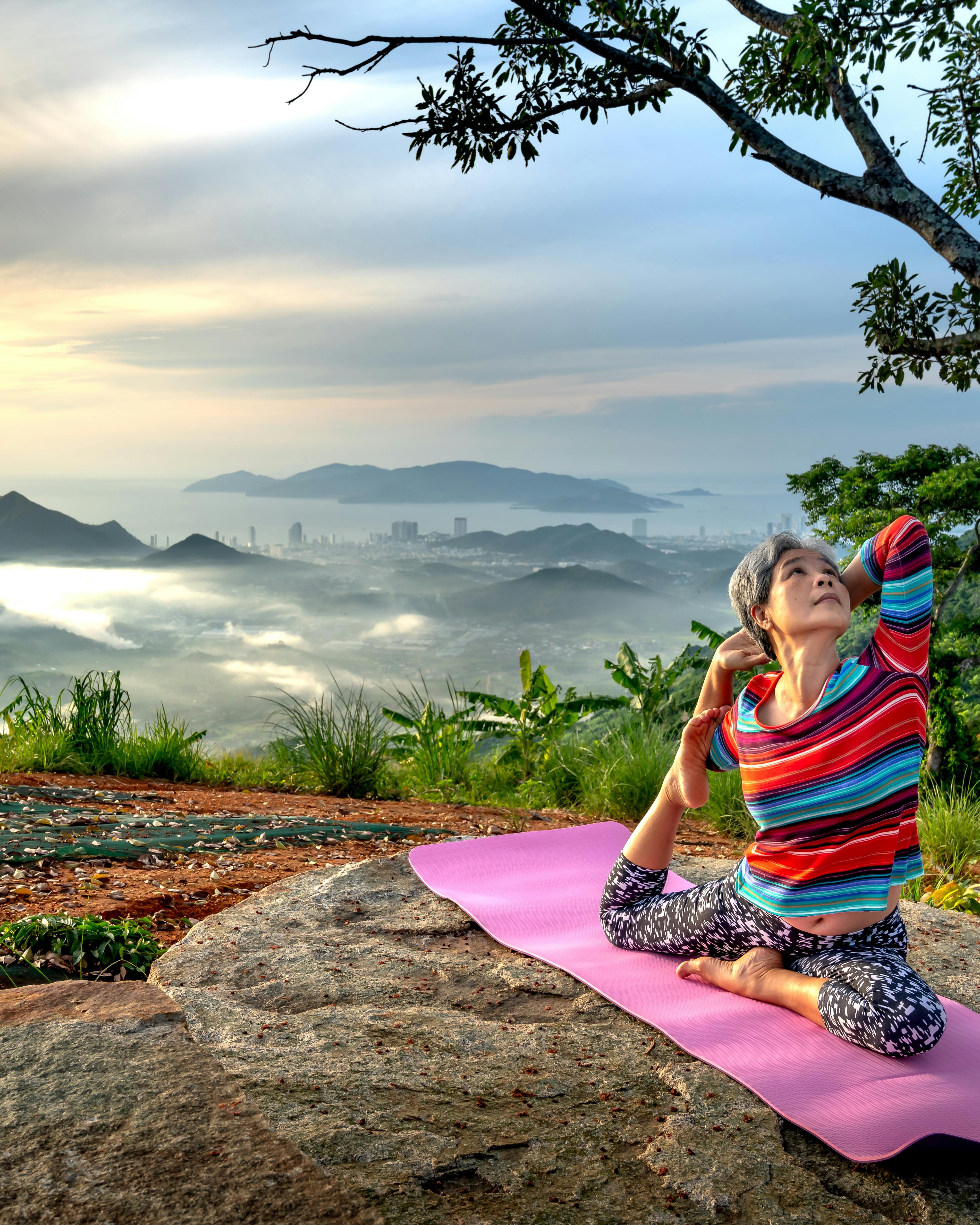 Senior Woman Practicing Yoga on Hilltop