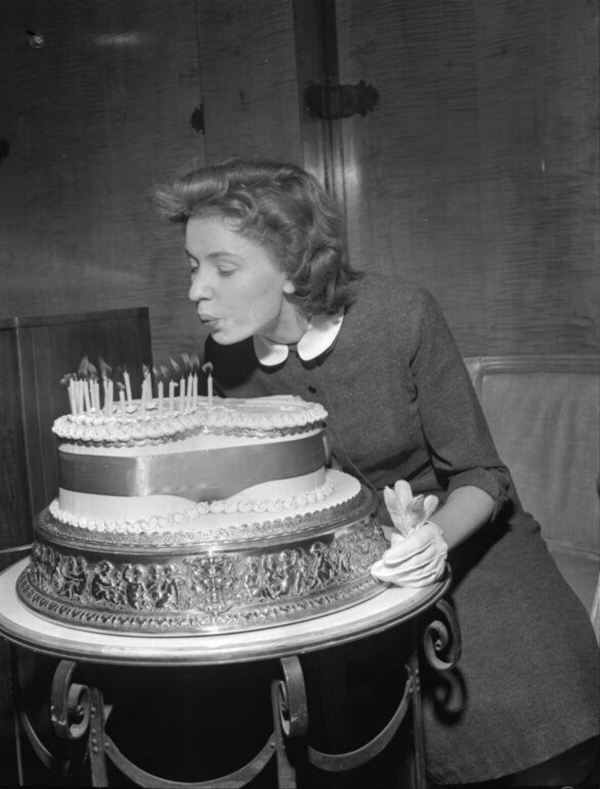 Woman Blowing Out Birthday Cake Candles