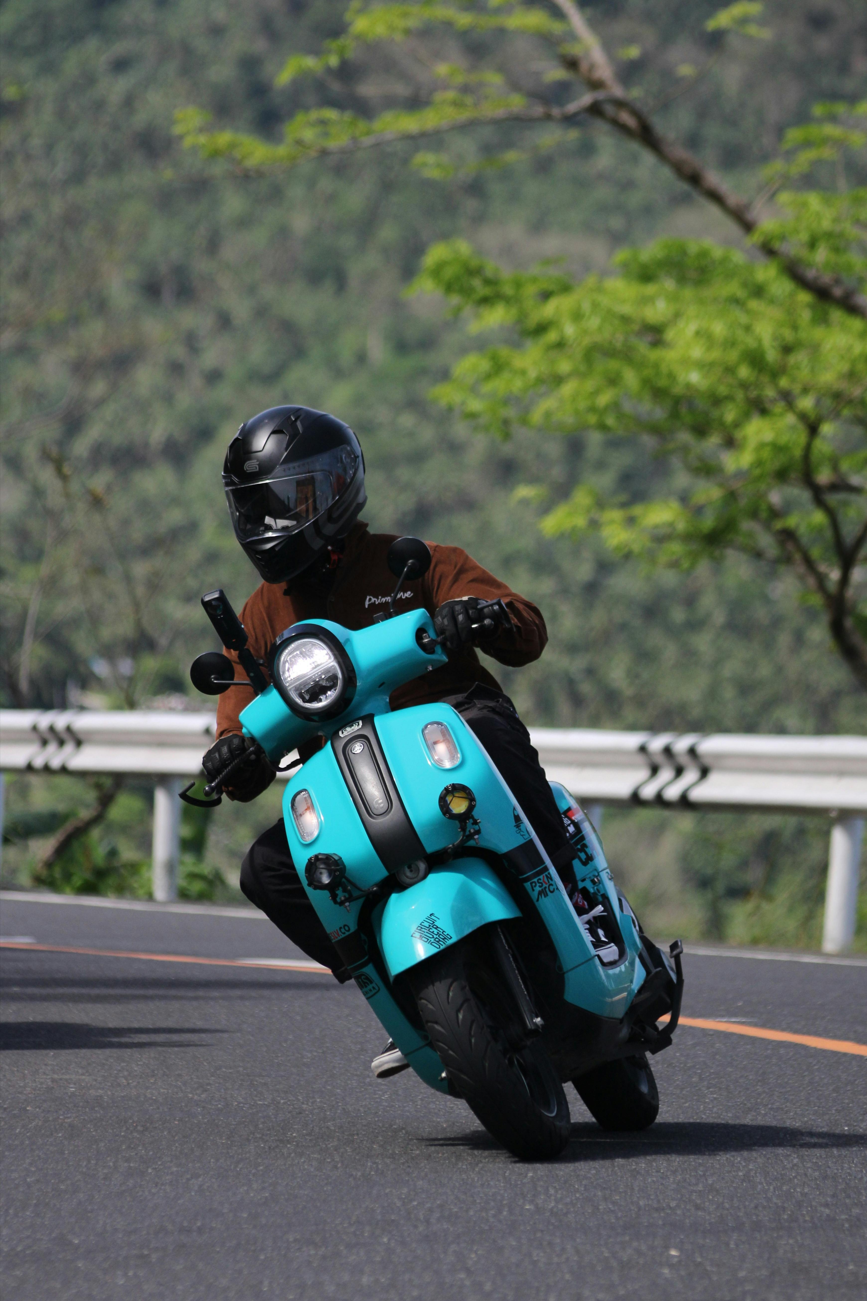 Scooter Rider on Mountain Road Curve