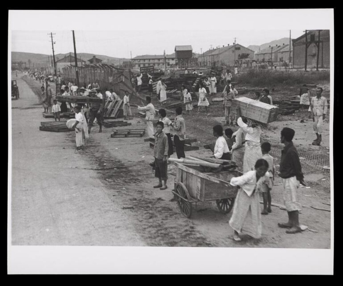 Civilians Sorting and Moving Lumber