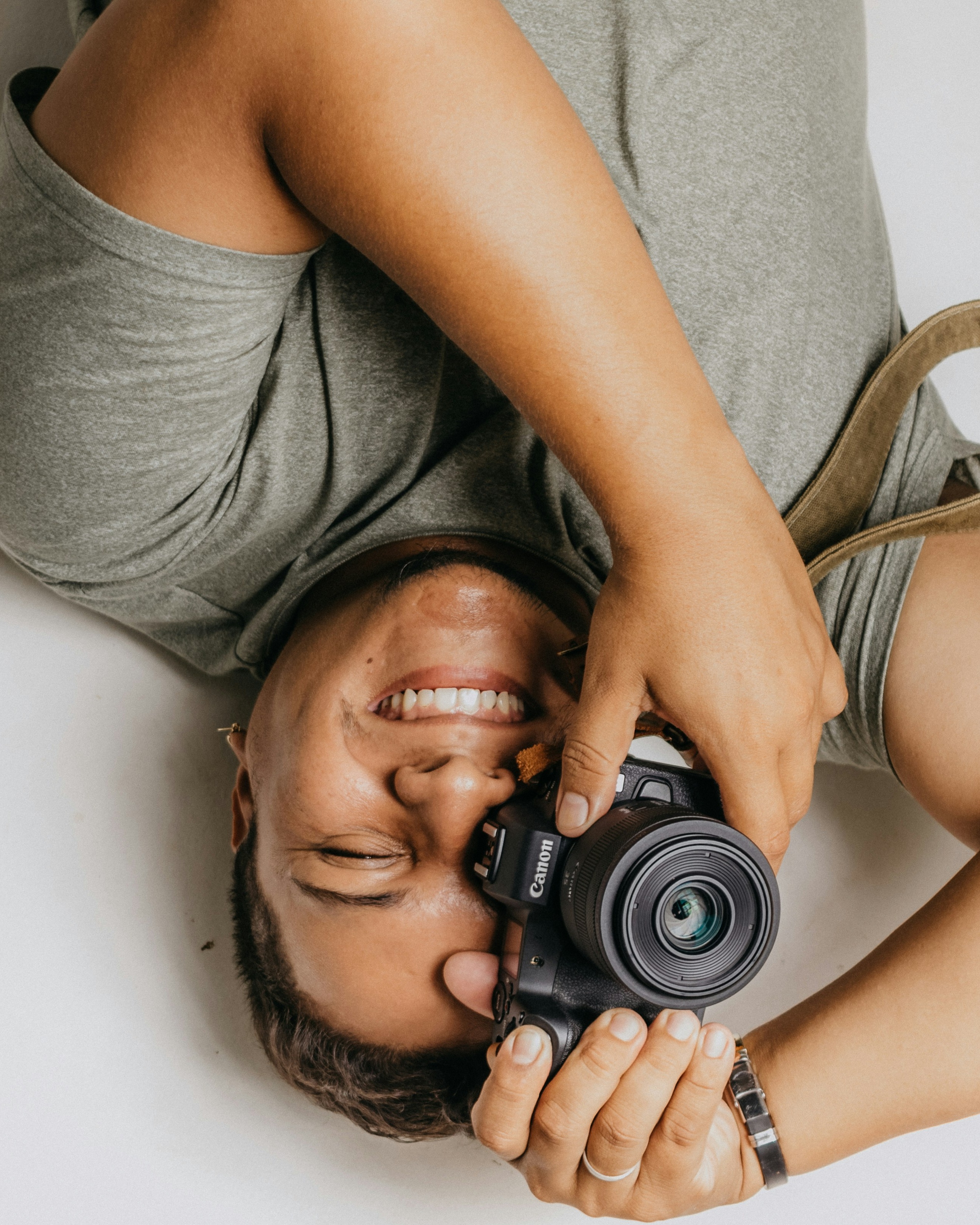 Smiling Photographer Holding Canon Camera