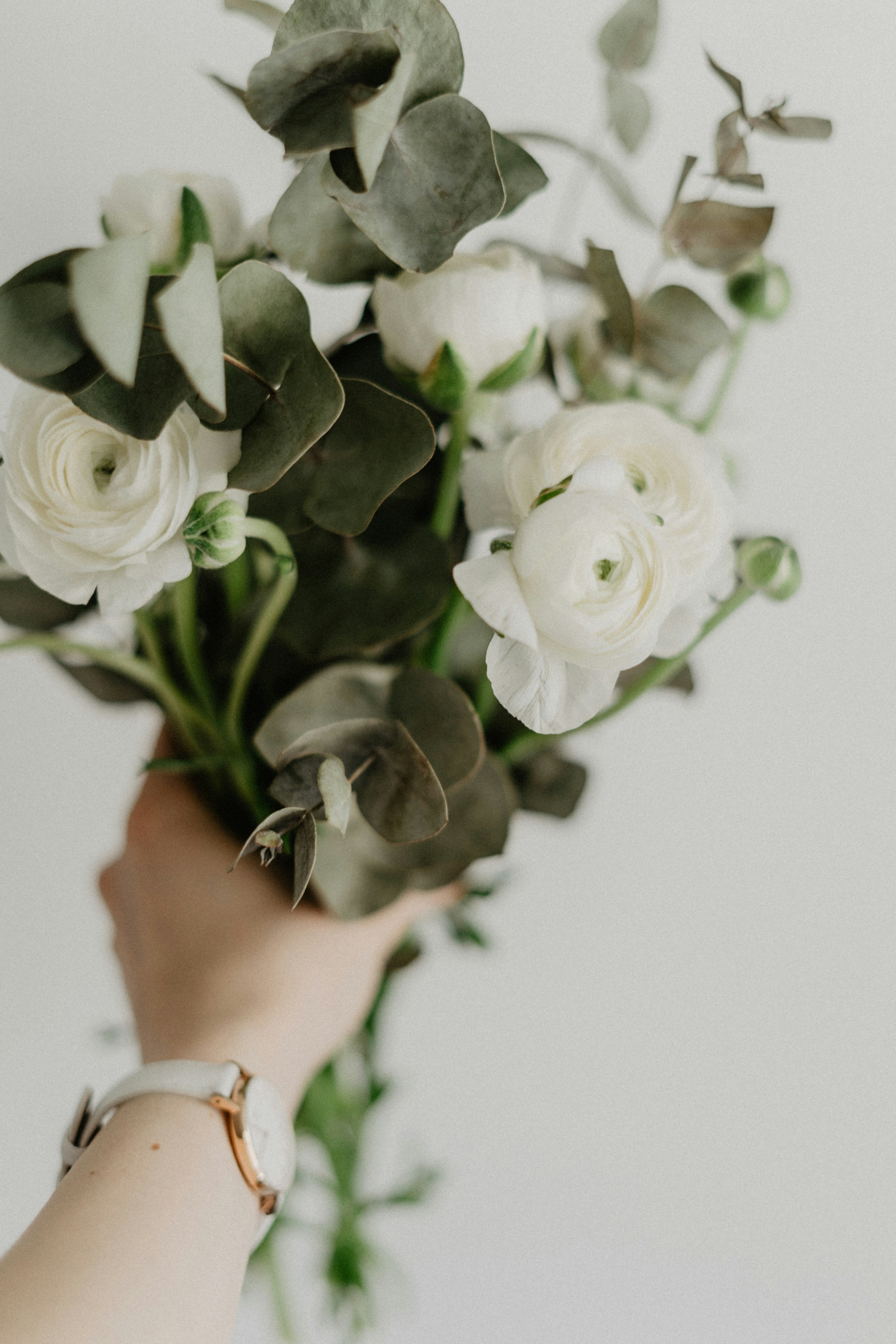 Hand Holding White Flower Bouquet