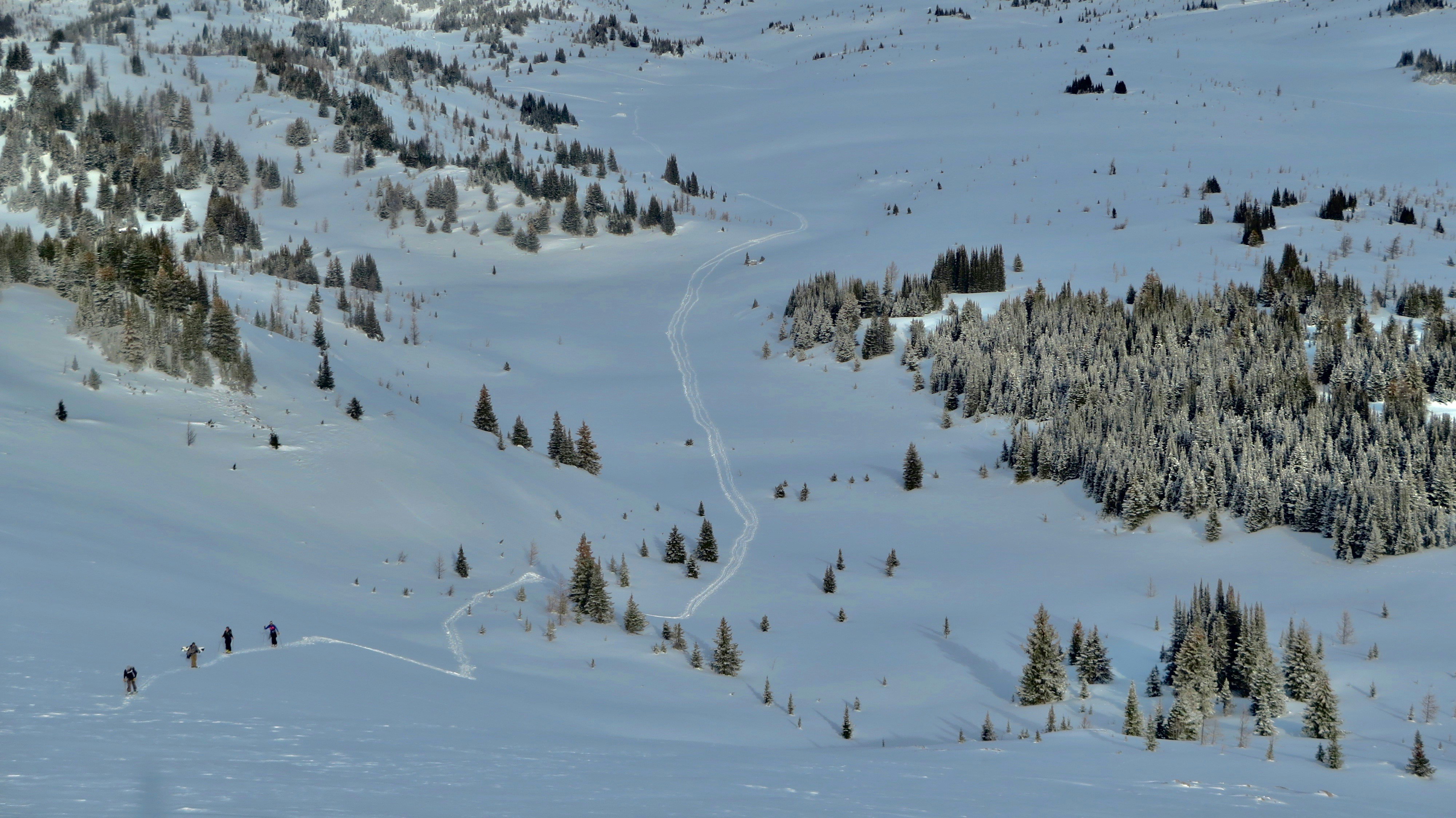 Skiers Ascending Snowy Mountain Slope