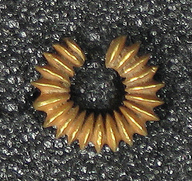 Golden Micro Cogwheel on Dark Background