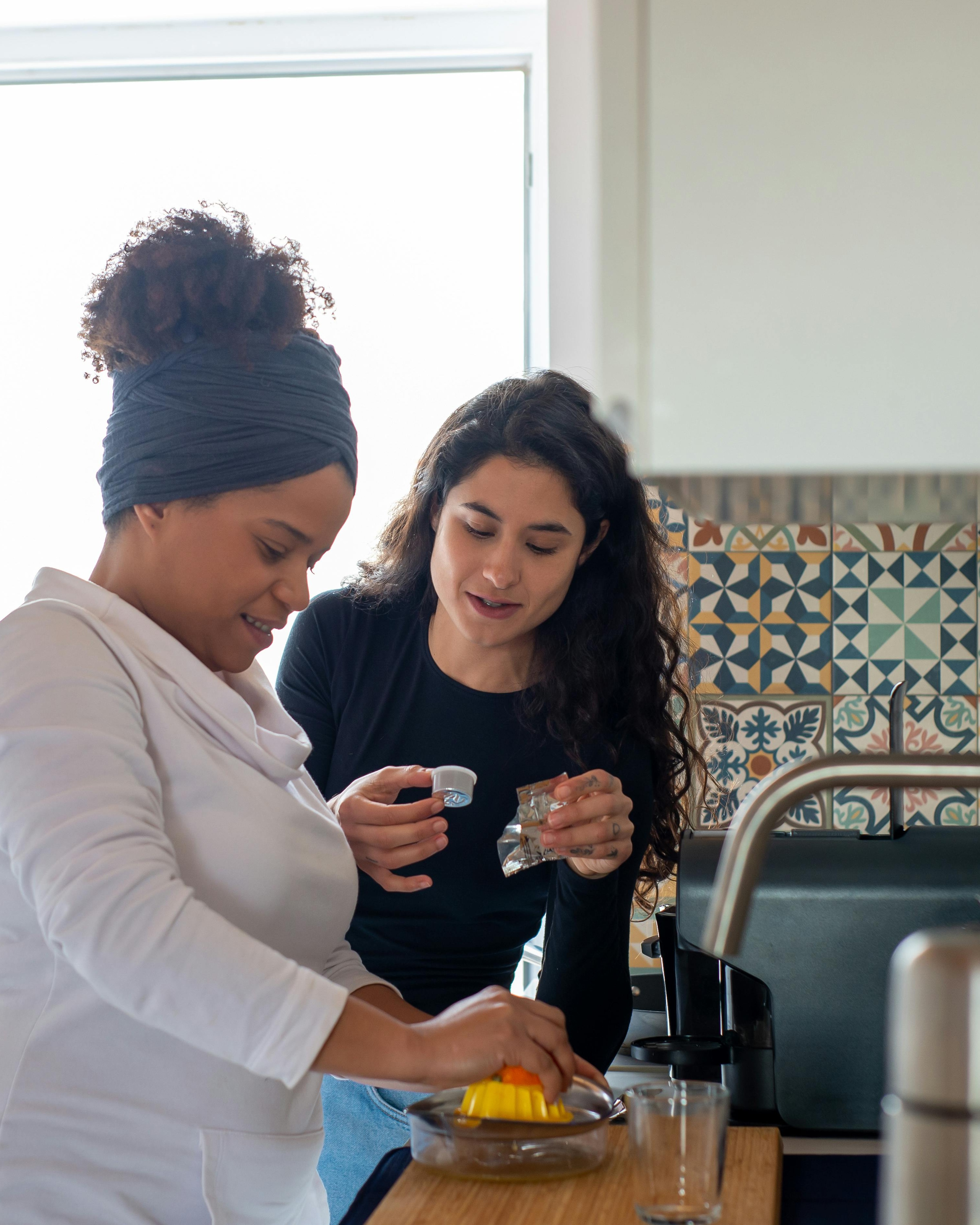 Two Women Preparing Coffee in Kitchen